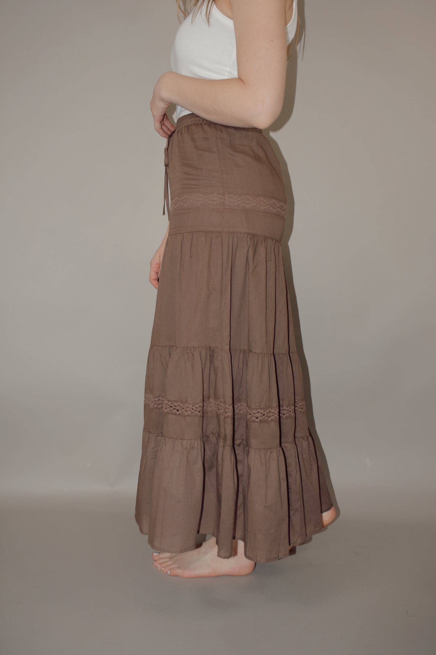 tiered maxi skirt with lace detailing and a elastic waistband with drawstring, has a liner