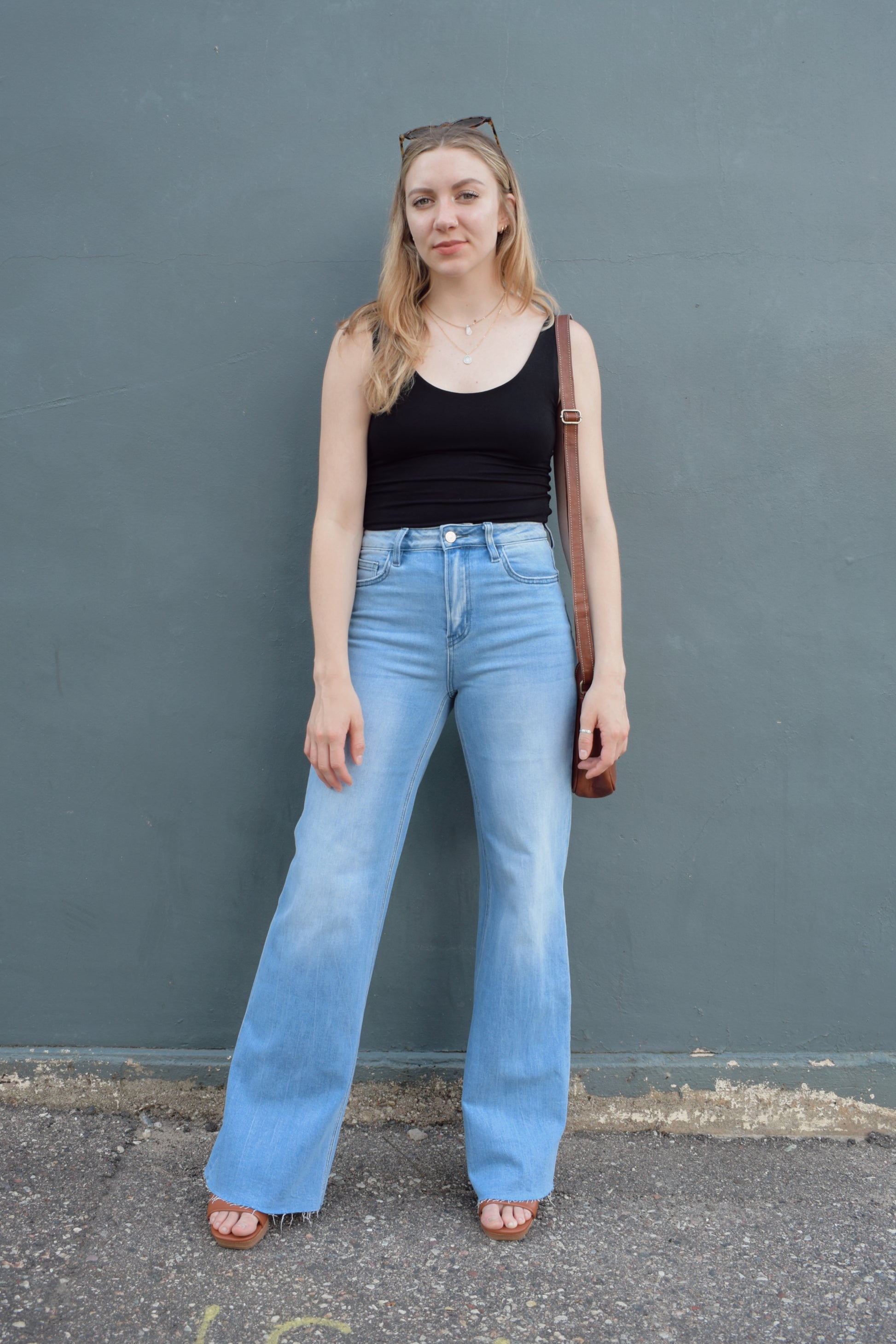 high rise full length wide leg jeans stretch denim raw hem light wash no distressing or holes, retro seam detailing above back pockets, zip and button enclosure