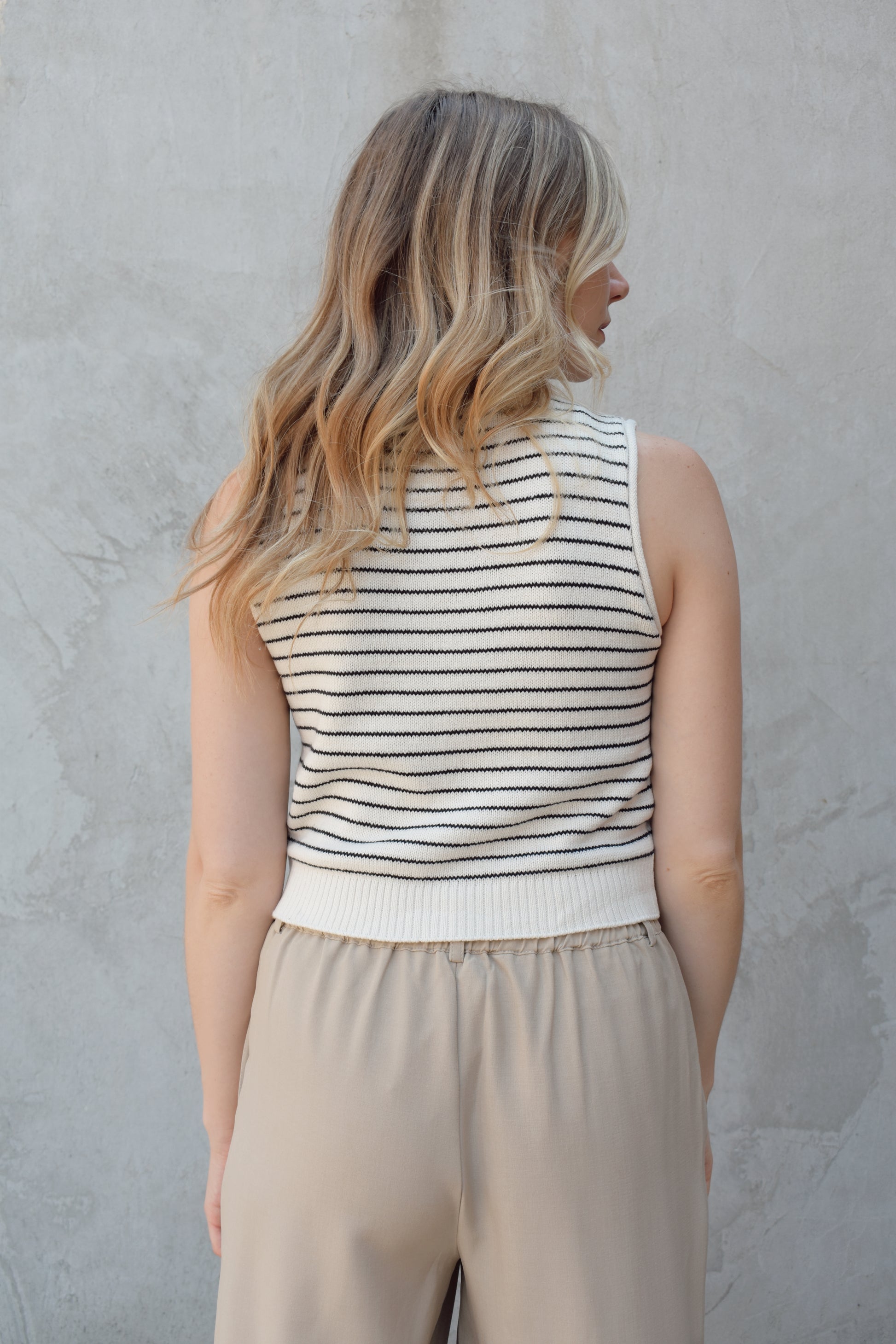 cropped striped sweater vest natural colored buttons down the front, crew neck, pin horizontal black stripes, solid ribbed hem