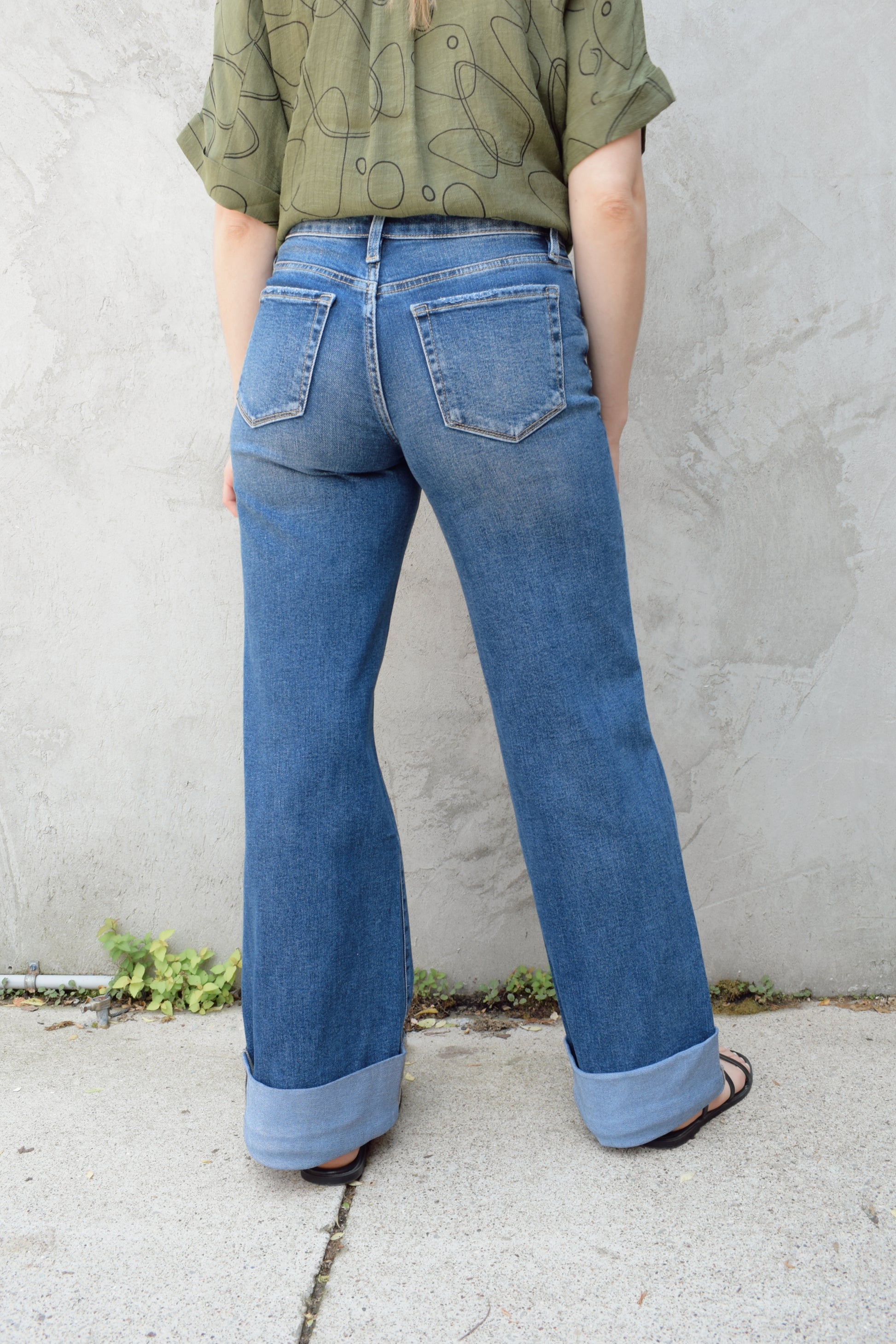 wide leg wide cuff at hem stretch denim jeans with holes in both knees, full length, dark wash, zip and button enclosure