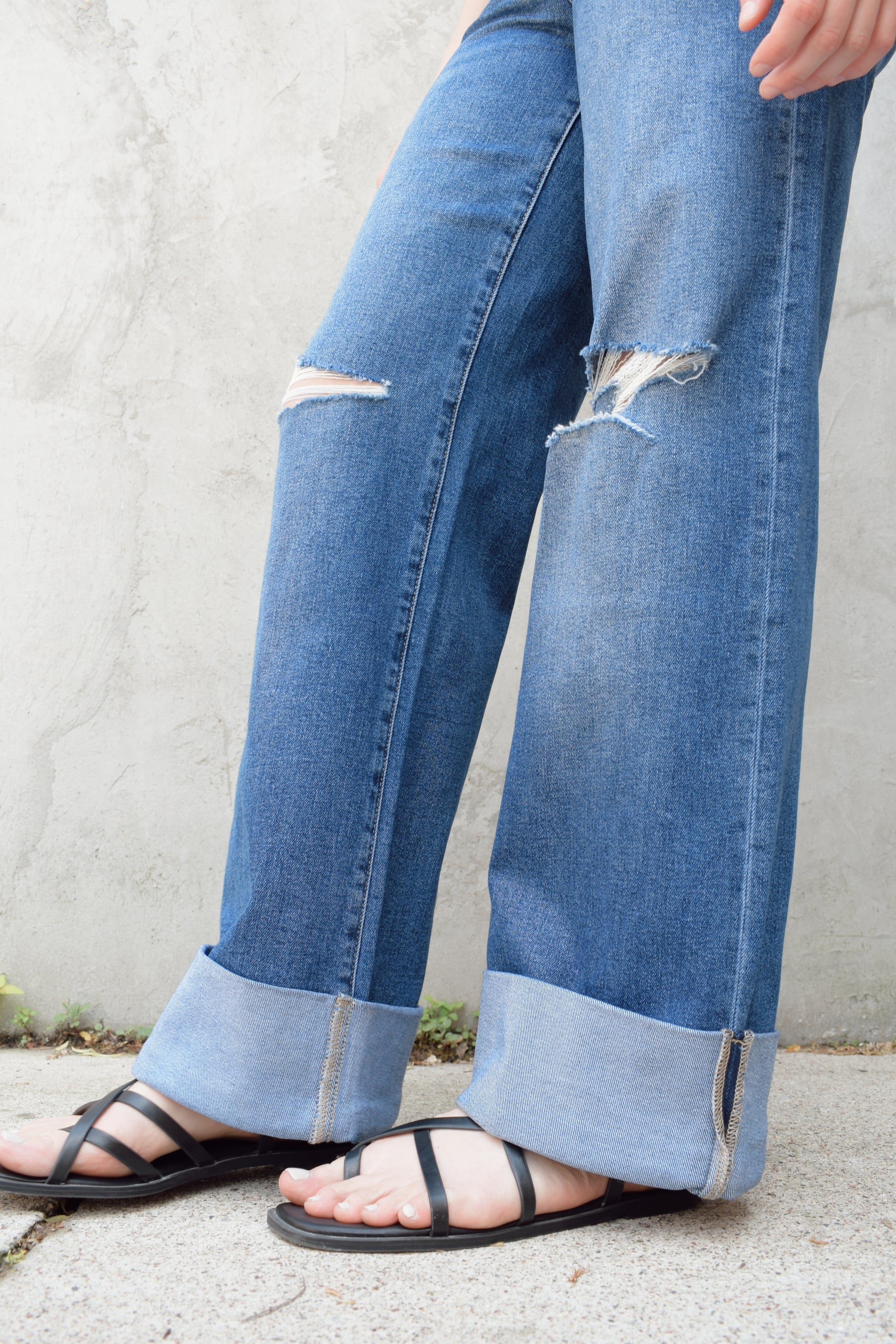 wide leg wide cuff at hem stretch denim jeans with holes in both knees, full length, dark wash, zip and button enclosure