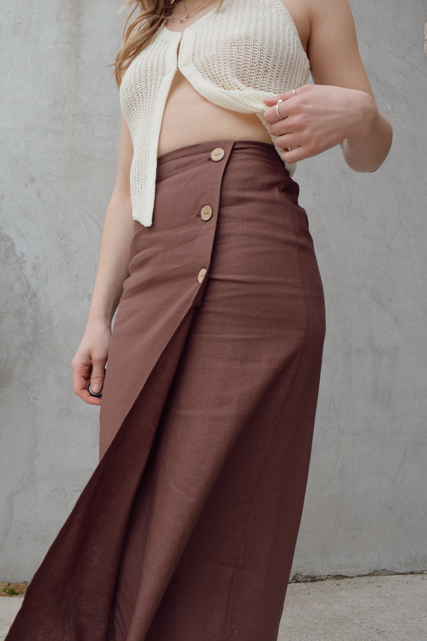 high waisted linen wrap skirt with 3 wooden button enclosure midi length stretch on back of waistband