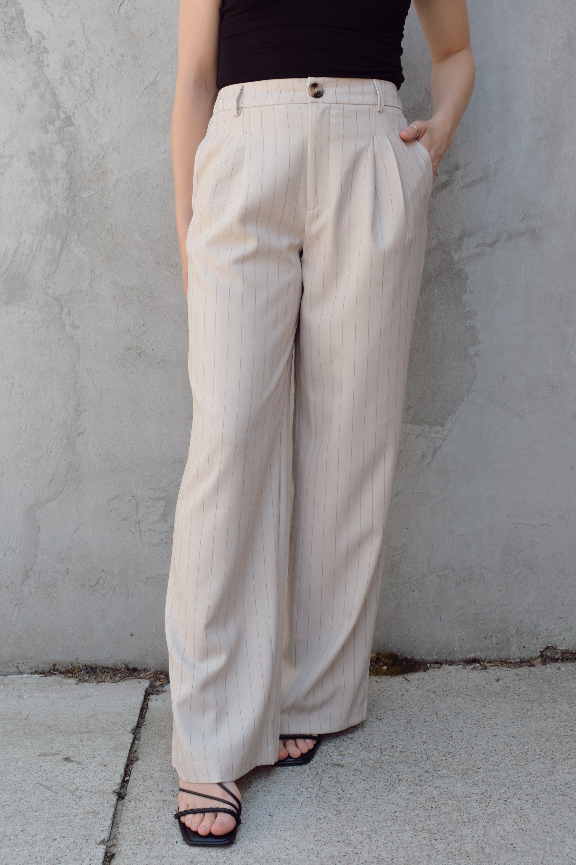 vertical pinstripe trousers with front pleats, pockets, zip and button enclosure, has beltloops, fake back pockets, elastic on back of waistband, full length