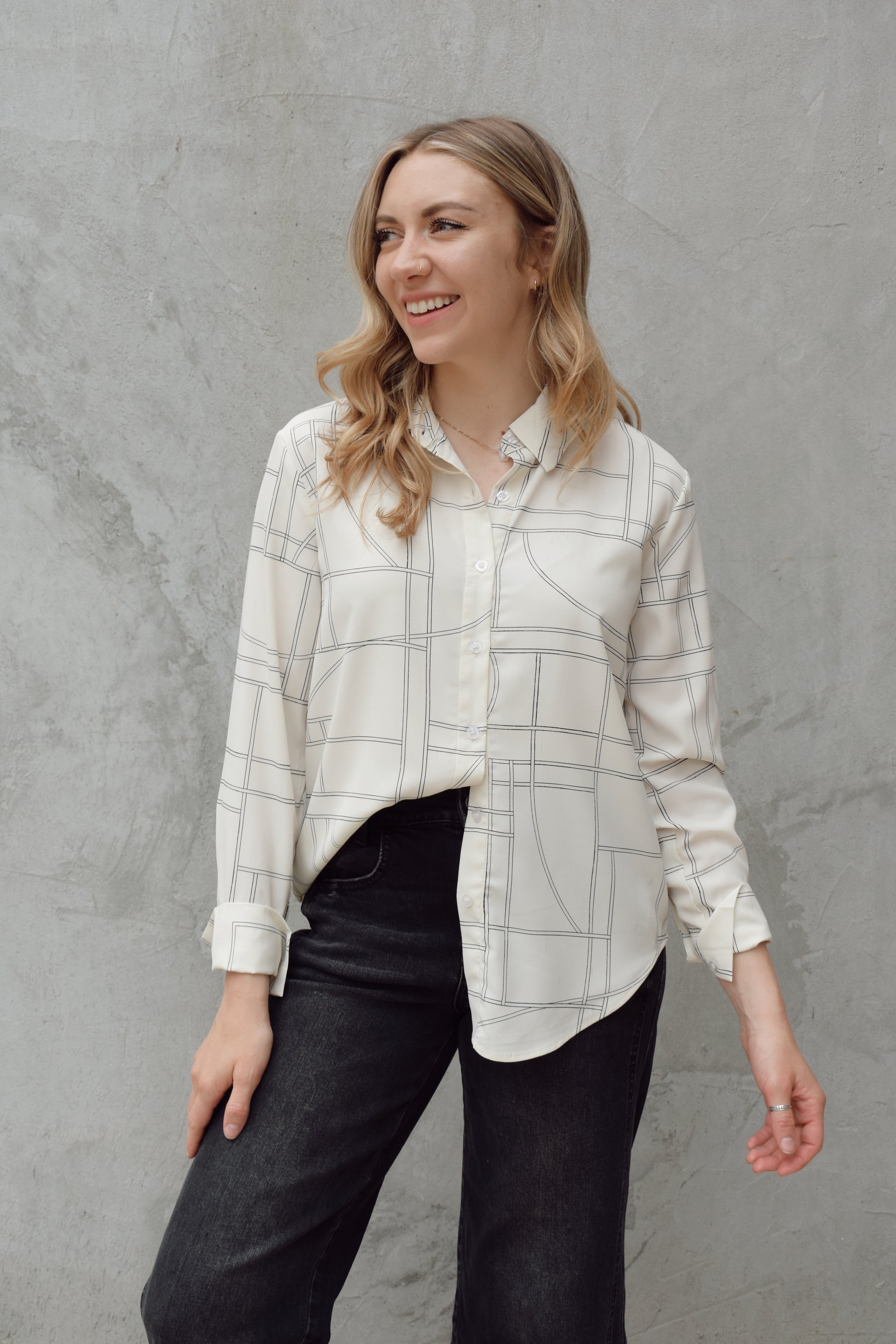 lightweight long sleeve off white button down blouse that has a chic geometric pattern, fitted cuffs, full length straight fit