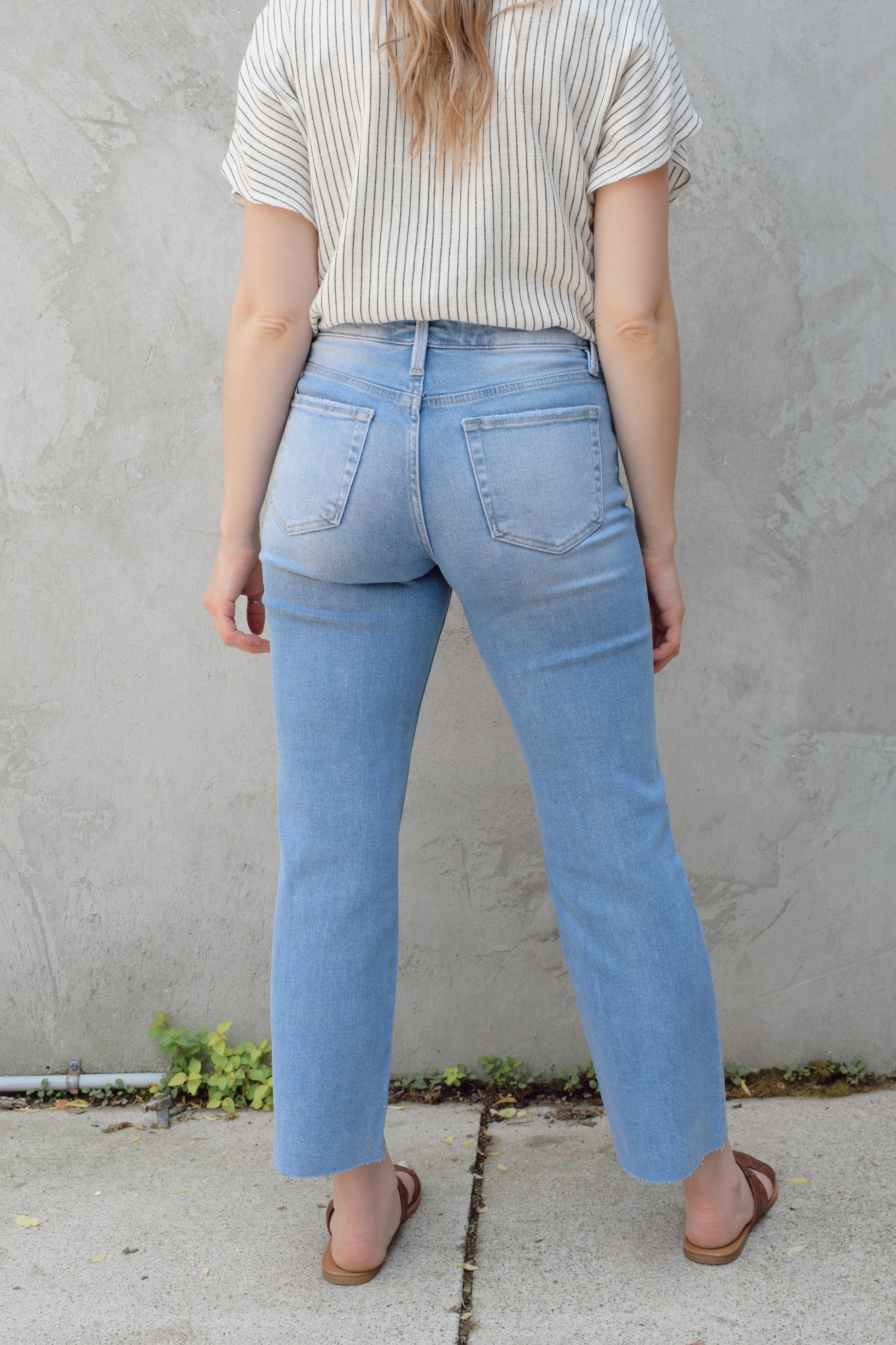 light wash slim wide leg cropped stretch denim with a raw hem and zip and button enclosure has beltloops and front and back pockets, no holes