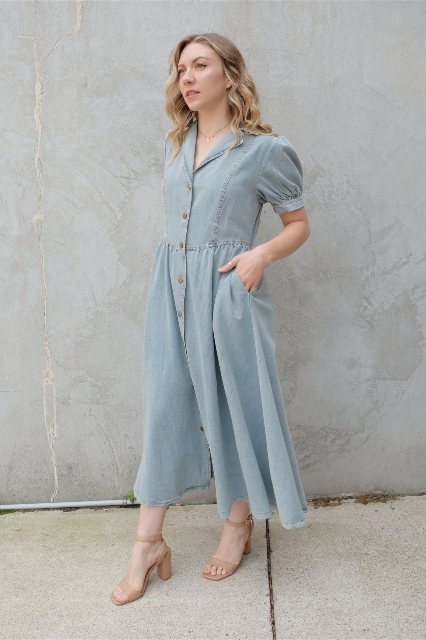 denim midi dress light wash with puff short sleeves with button cuffs button down front, v neck and collar, gathered at waist with a line skirt, has pockets