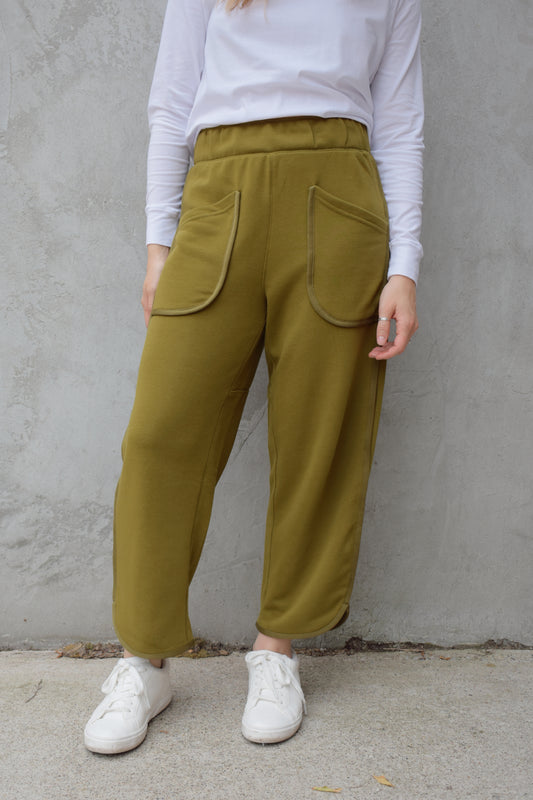 lounge pants with relaxed cropped fit, curved hem, oversized front bucket patch pockets, elastic waistband, seam detailing along sides, athleisure
