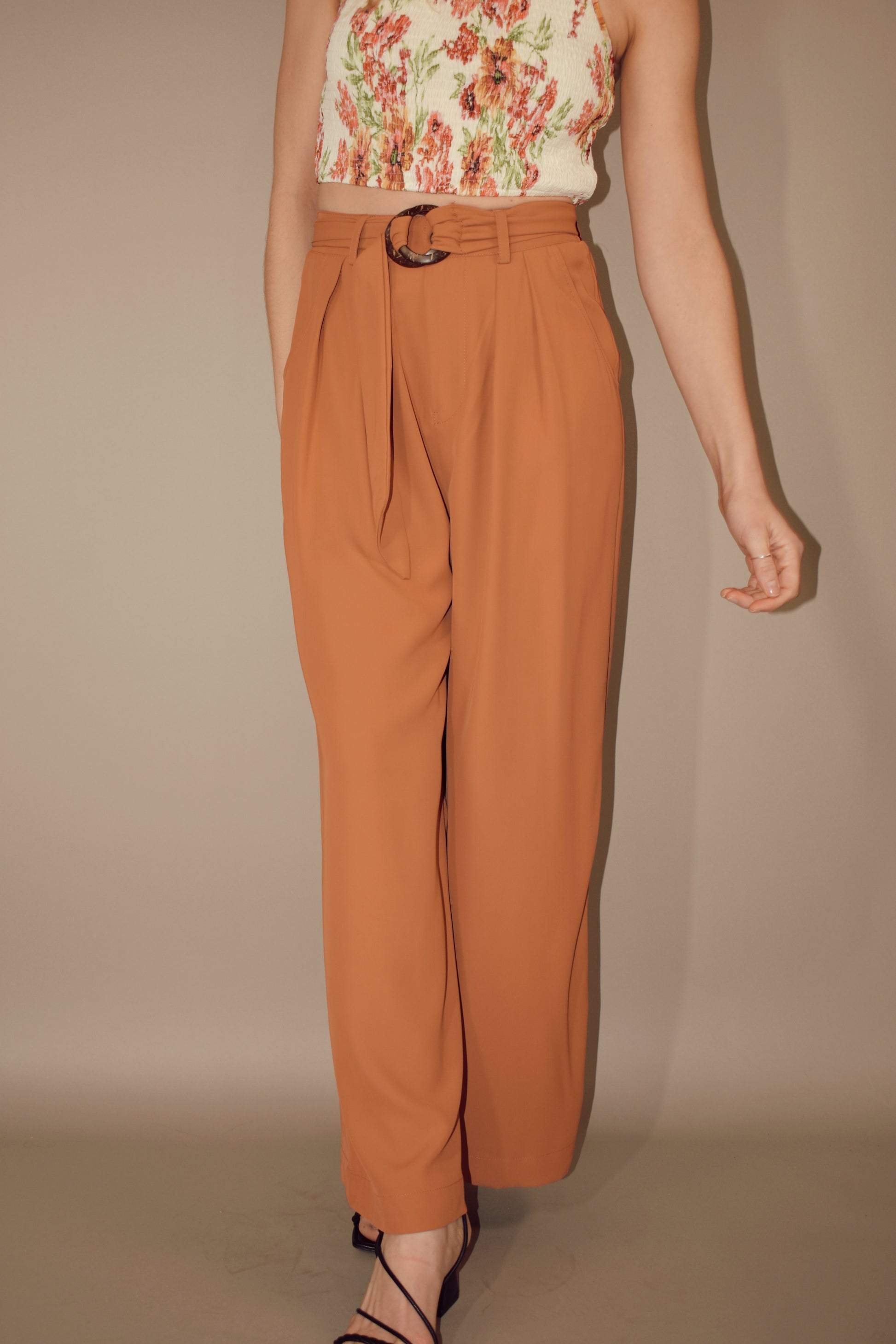 Wide leg pleated full length trousers with side pockets and an o ring knot belt. 