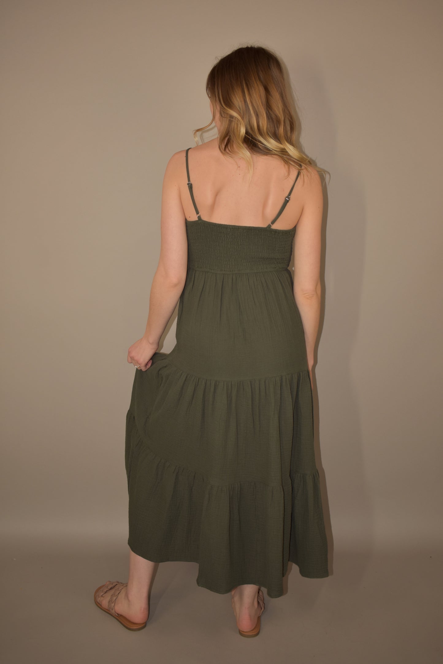 Tiered midi spaghetti strap dress. olive green. lightweight fabric. adjustable straps. flowy but fitted bodice. smocked/ stretchy back.   