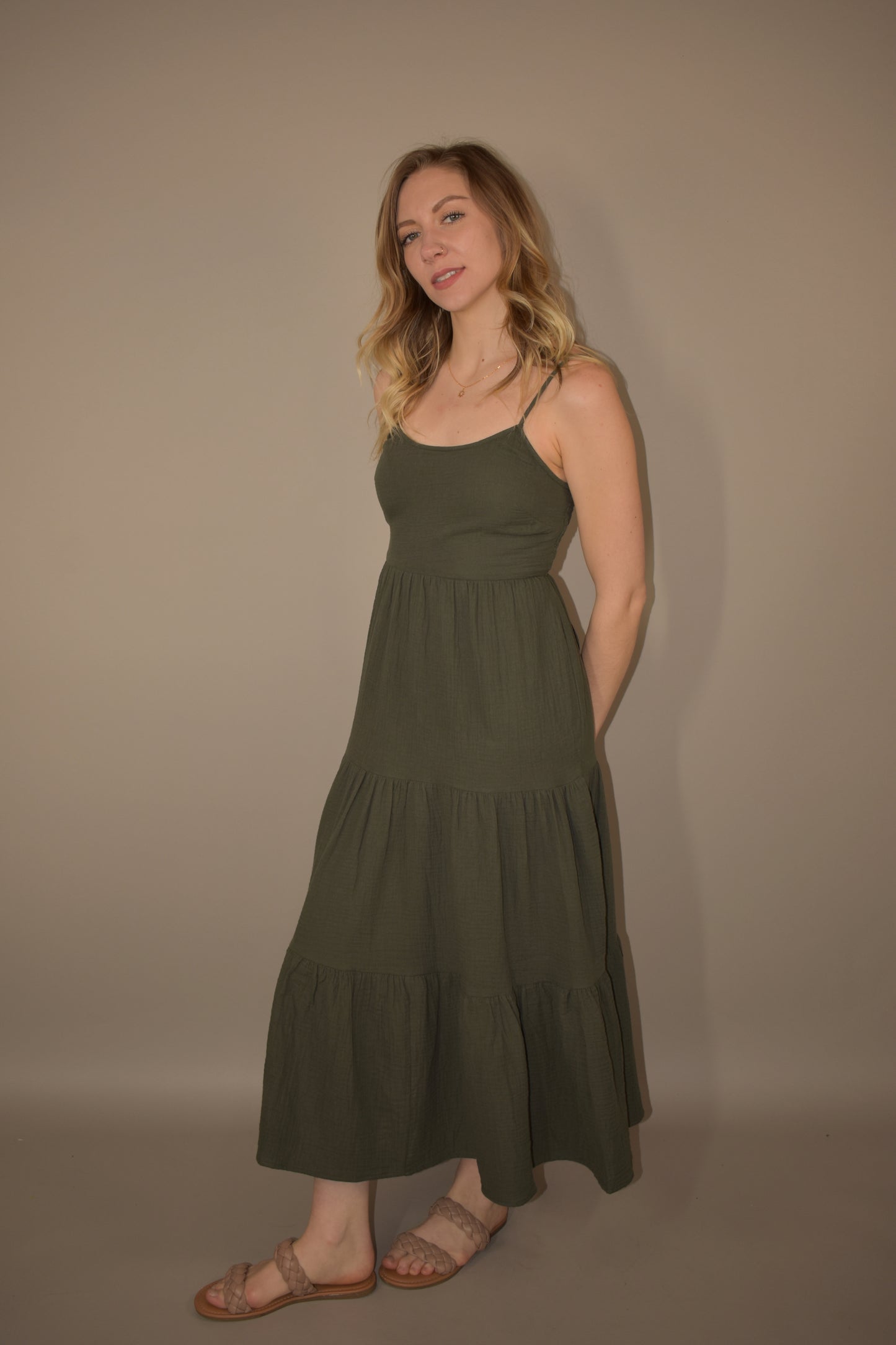 Tiered midi spaghetti strap dress. olive green. lightweight fabric. adjustable straps. flowy but fitted bodice.  smocked/ stretchy back.   