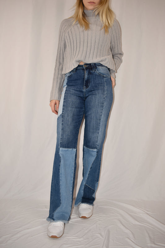 boyfriend/straight leg style jeans with stretch denim. Patchwork style ranging from medium to light wash. frayed hem, full length.