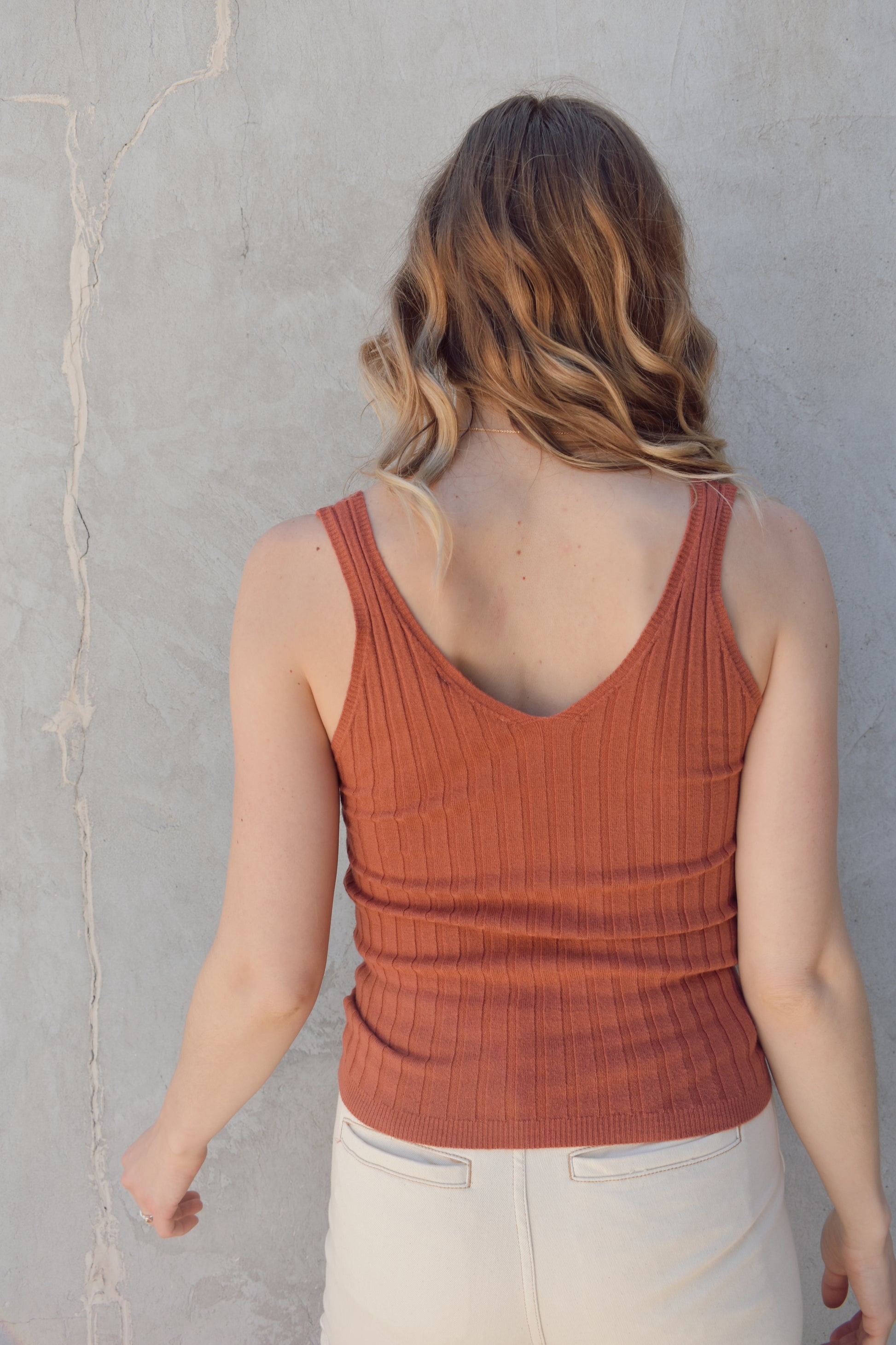 v neck sweater tank with wide ribbed texture. lightweight. stretchy. full length. fitted.