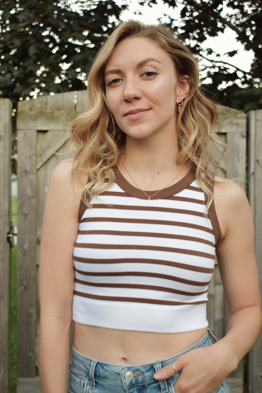 cropped tank with horizontal stripes. thick band of white around bottom hem. arm and neck line hem are solid color. crew neck. stretchy. 