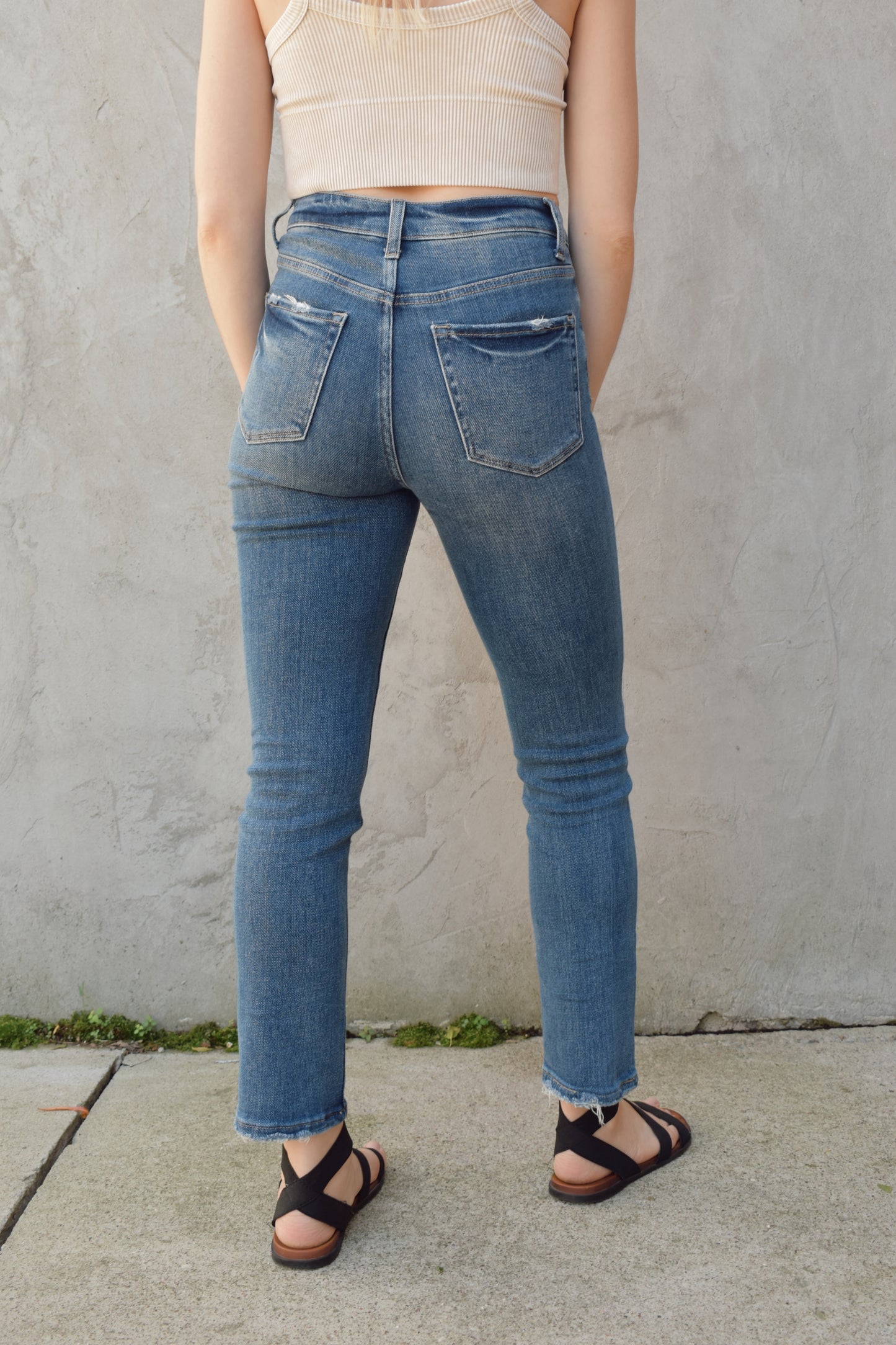 medium to dark wash straight jeans length sits at ankle slight distressing at hem no holes high rise stretch denim wash mark detailing and slight distressing on back pockets