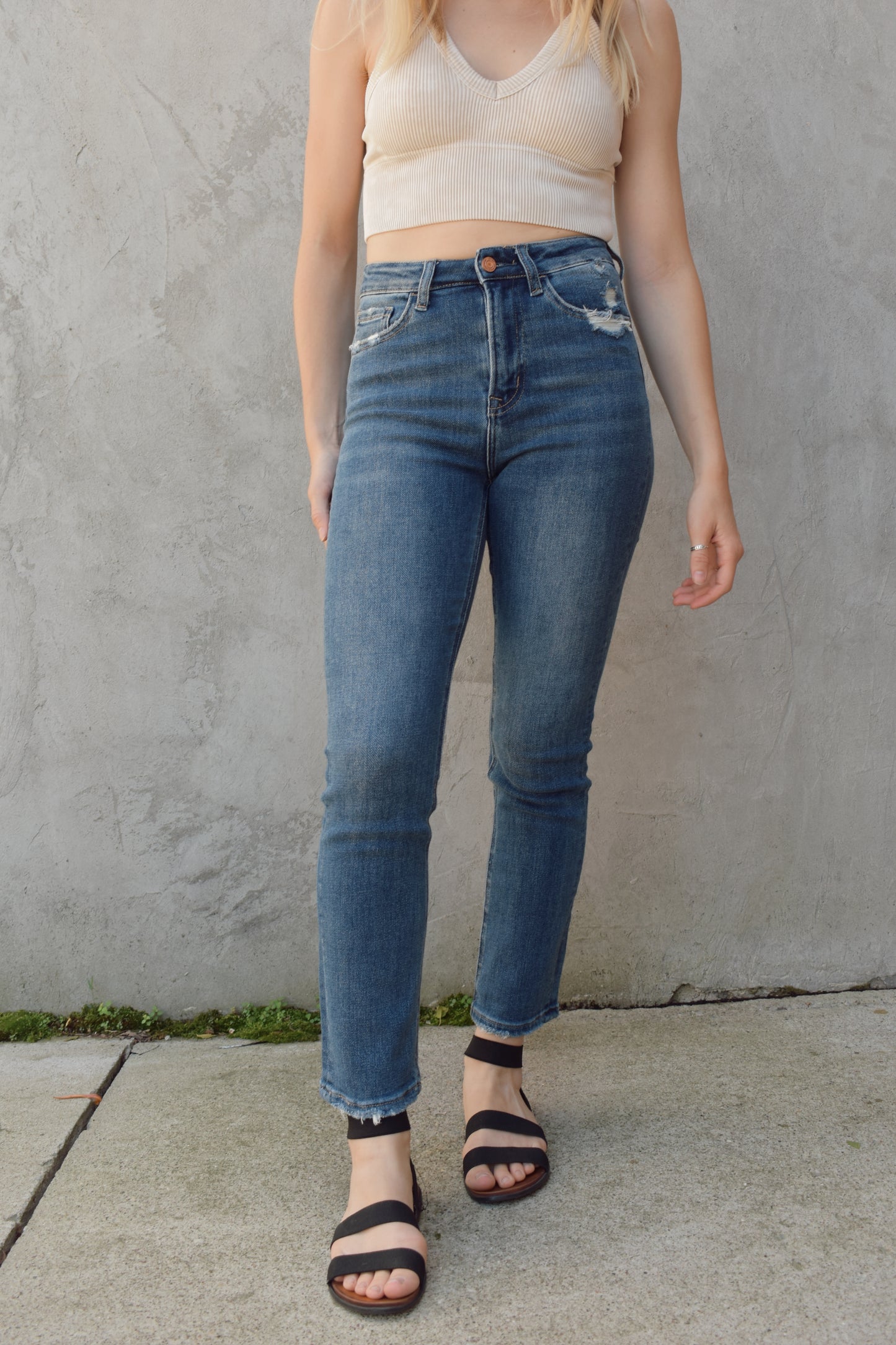 medium to dark wash straight jeans length sits at ankle slight distressing at hem no holes high rise stretch denim wash mark detailing and slight distressing on back pockets