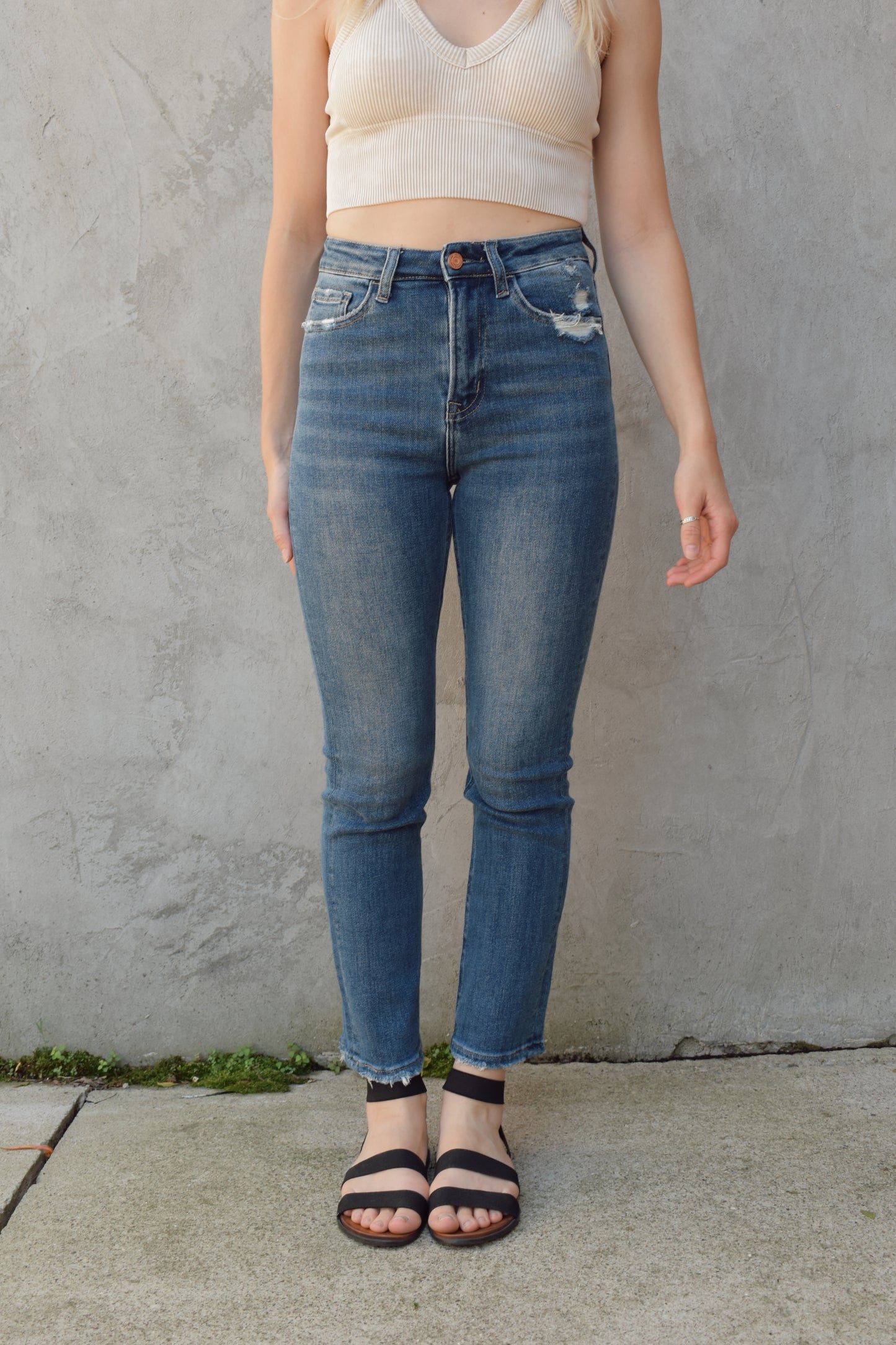 medium to dark wash straight jeans length sits at ankle slight distressing at hem no holes high rise stretch denim wash mark detailing and slight distressing on back pockets