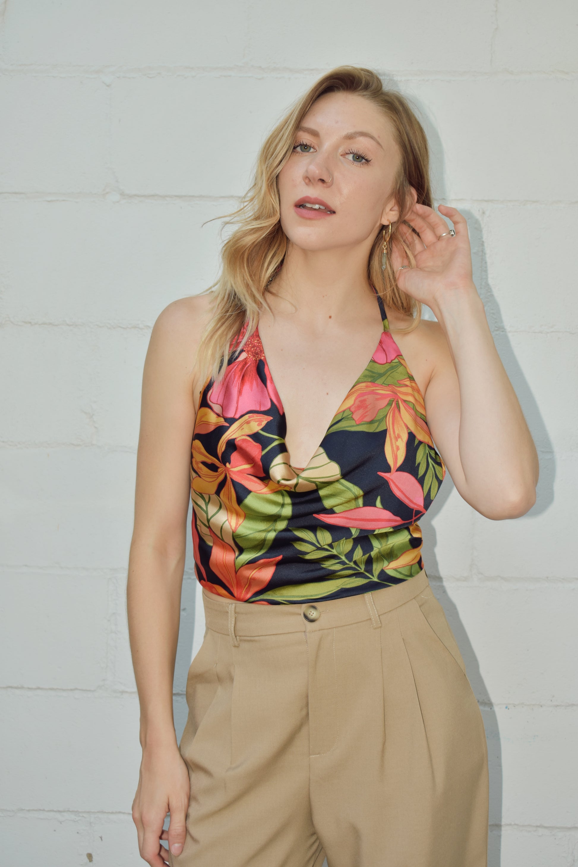 Satin tropical halter top cropped with tie on botton and the neck strap is adjustable. slouchy cowl neck. black background with large colorful botanical print