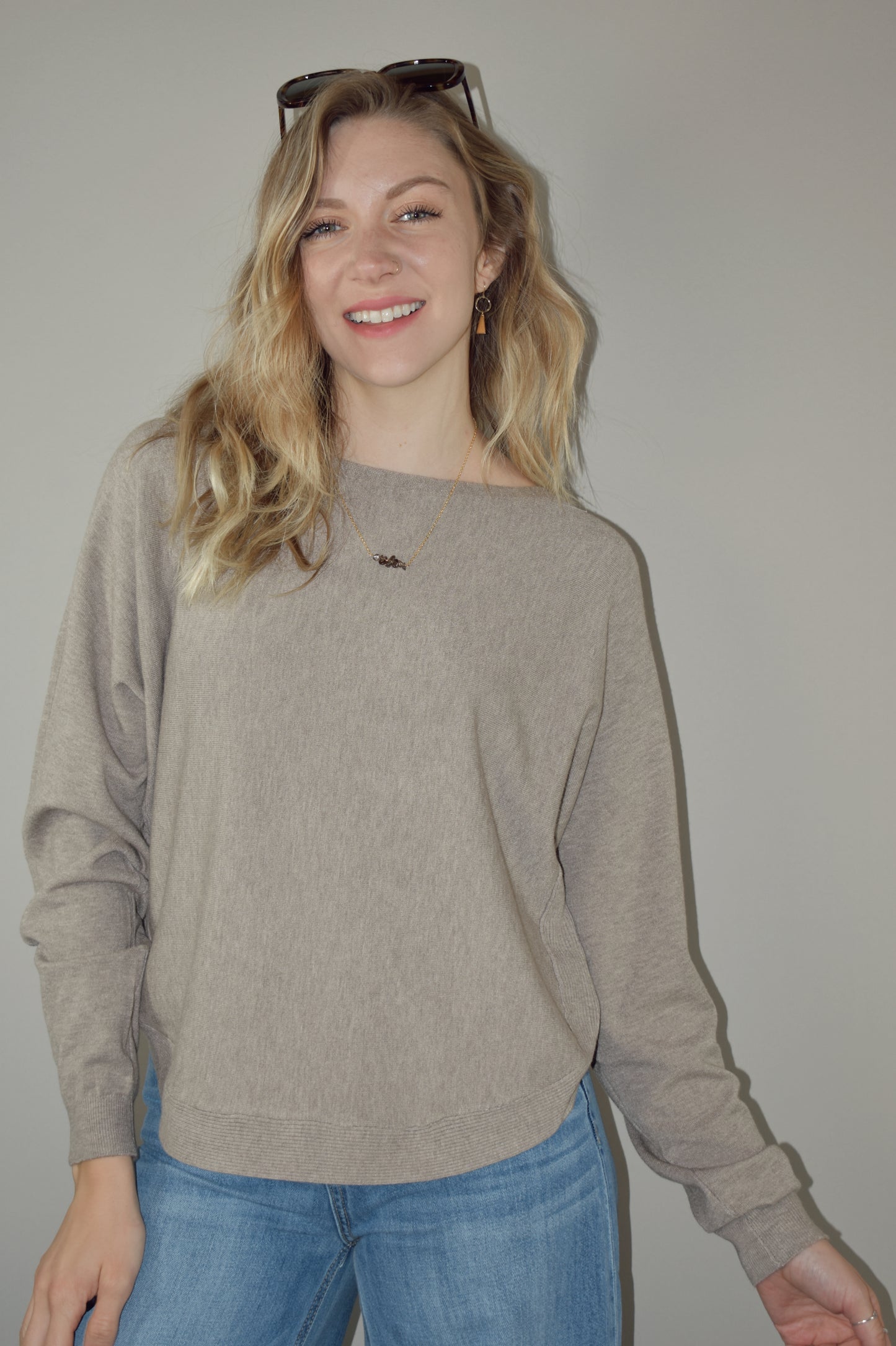 boat neck style pullover sweater with scooped hem and super soft fabric