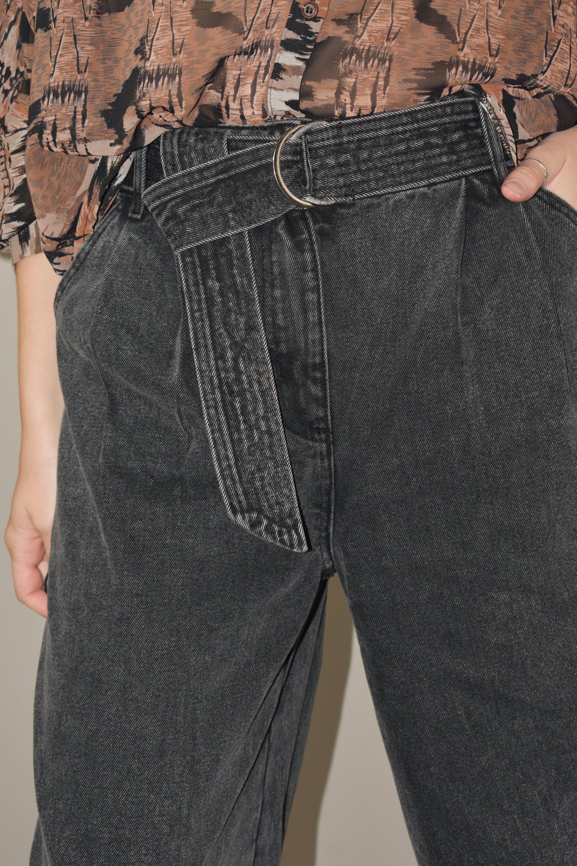 high waisted belted denim trousers wide leg with side pockets, front pleats ,zip and button enclosure, no holes or distressing, grey black wash