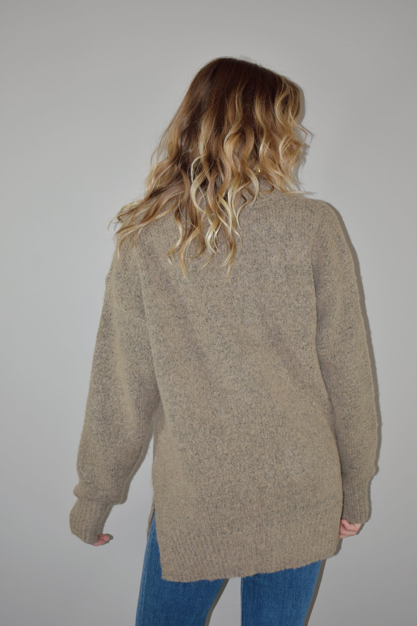 oversized sweater with v criss cross neck with ribbed detailing on neckline, hem and cuffs. two tone knit. side slits on hem