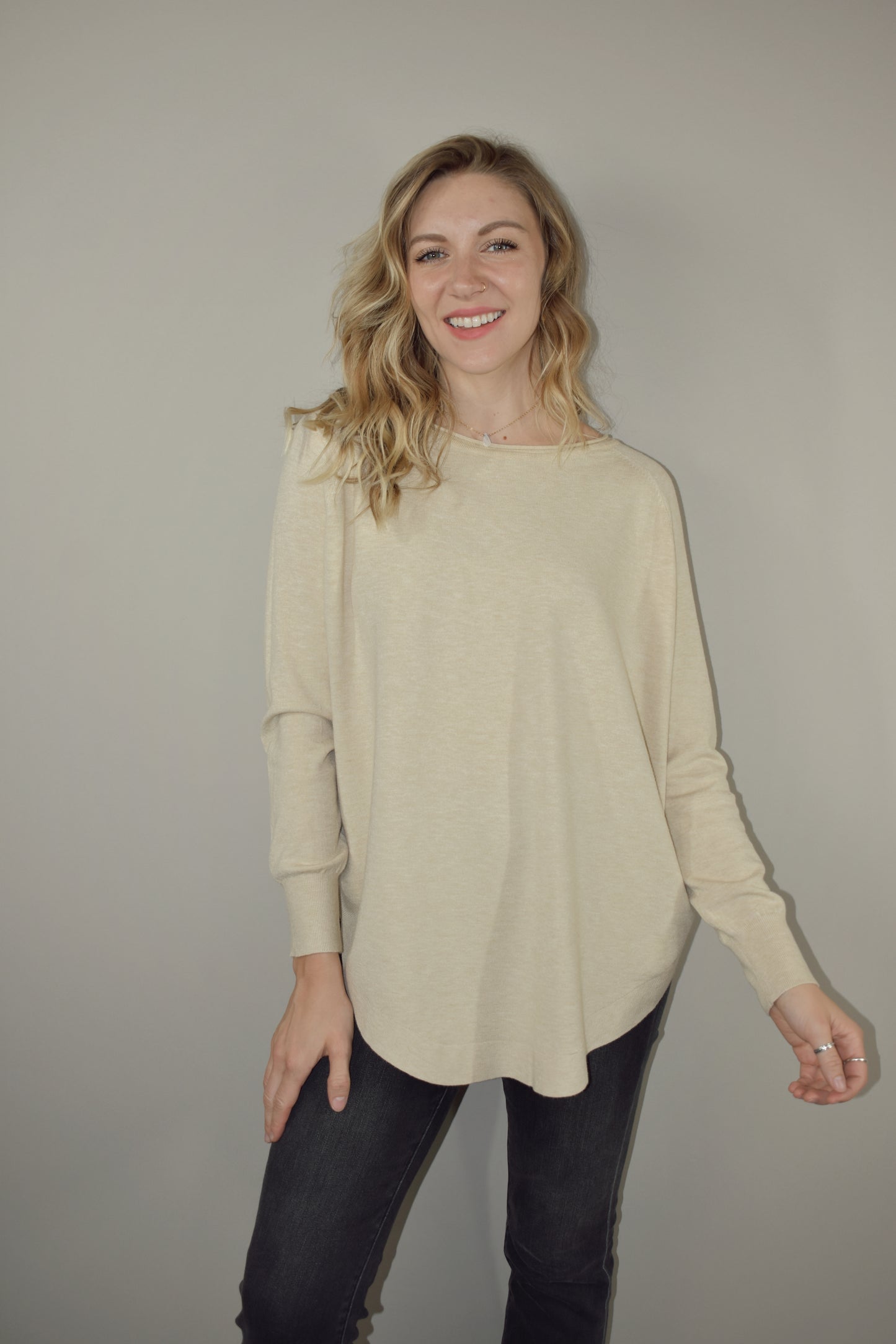 Long boat/crew neck tunic sweater with tight cuffs and scooped hem that comes up on the sides super soft material 