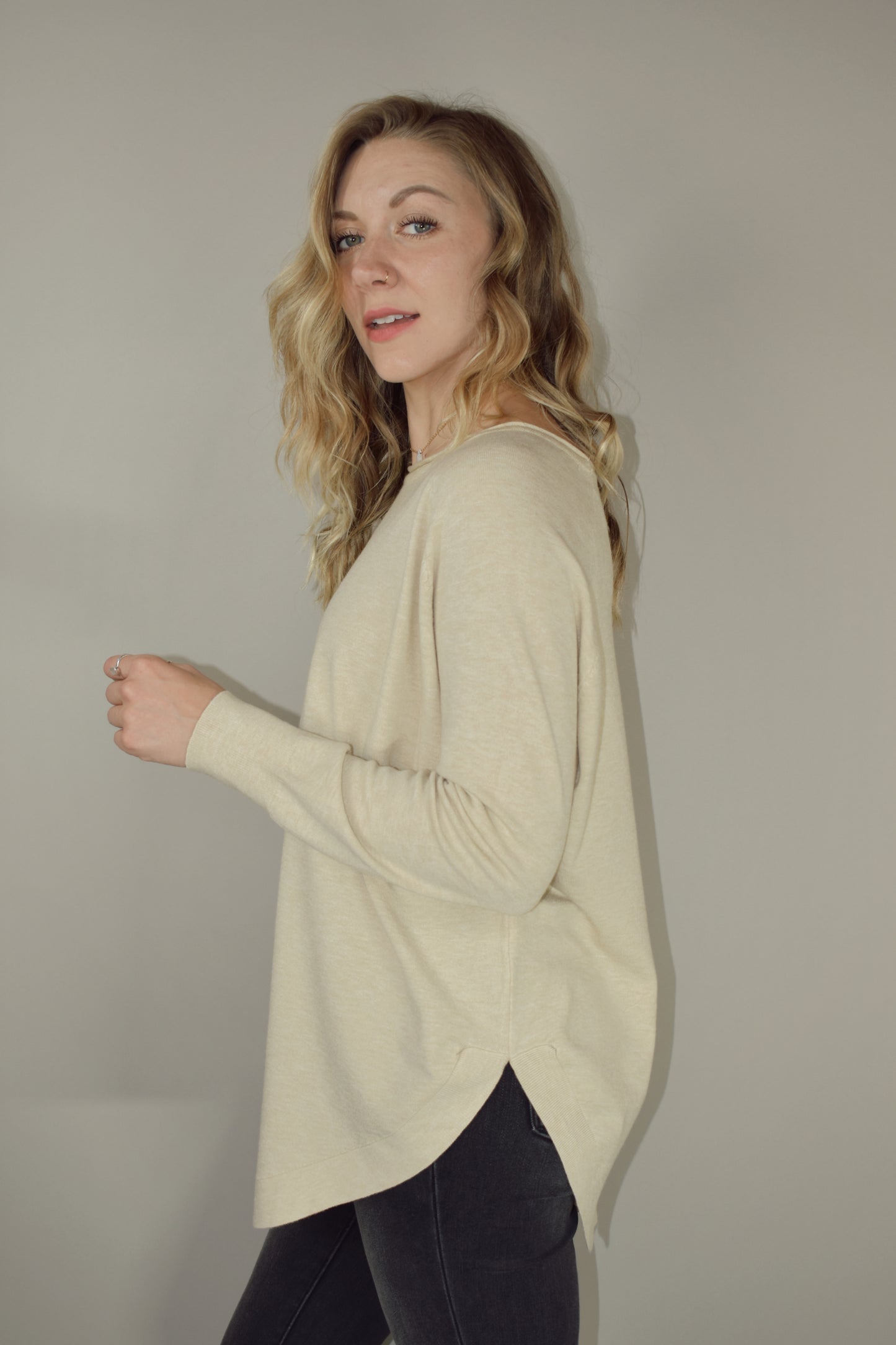 Long boat/crew neck tunic sweater with tight cuffs and scooped hem that comes up on the sides super soft material 