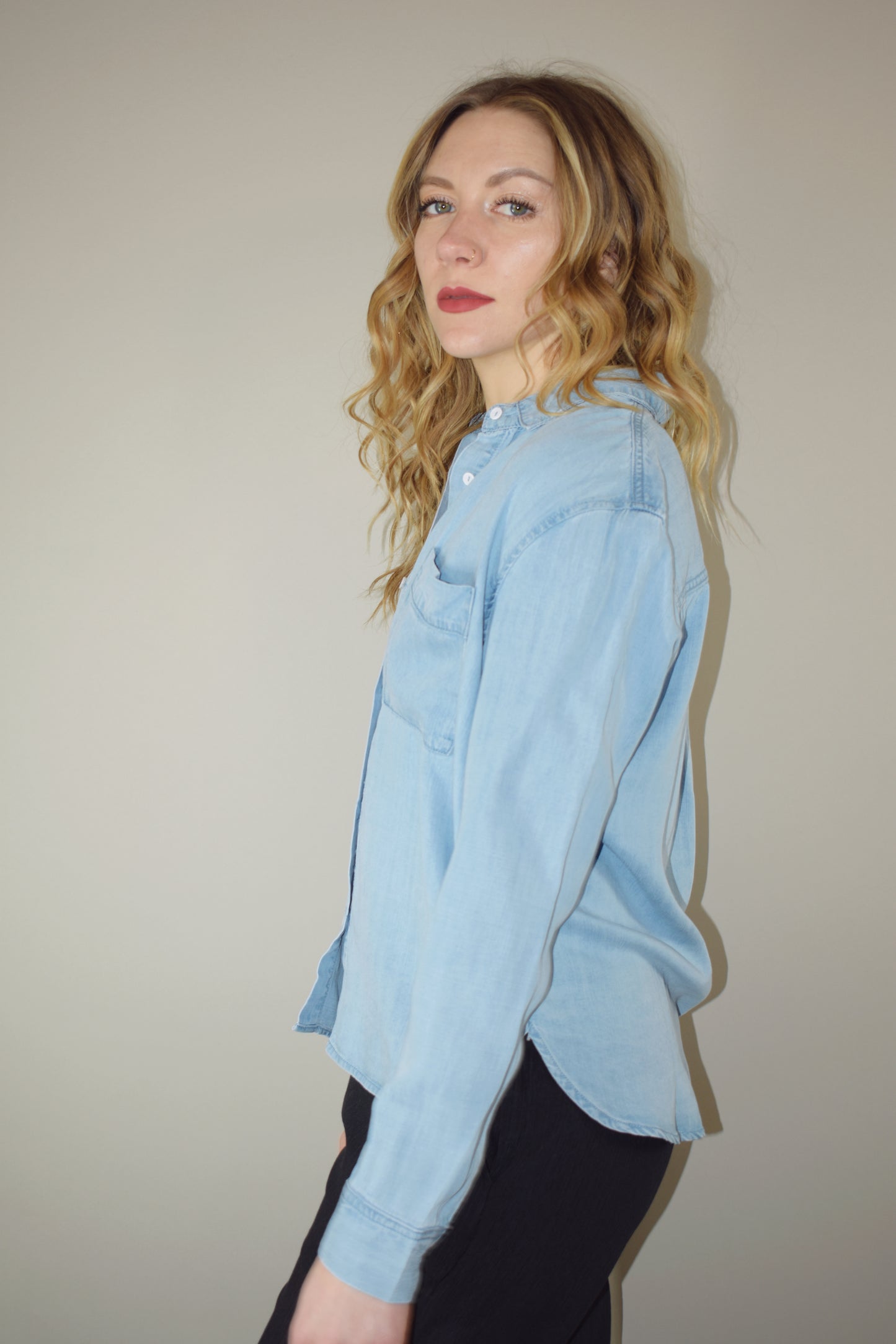 Tencel light wash denim long sleeve button down with one breast patch pocket full length