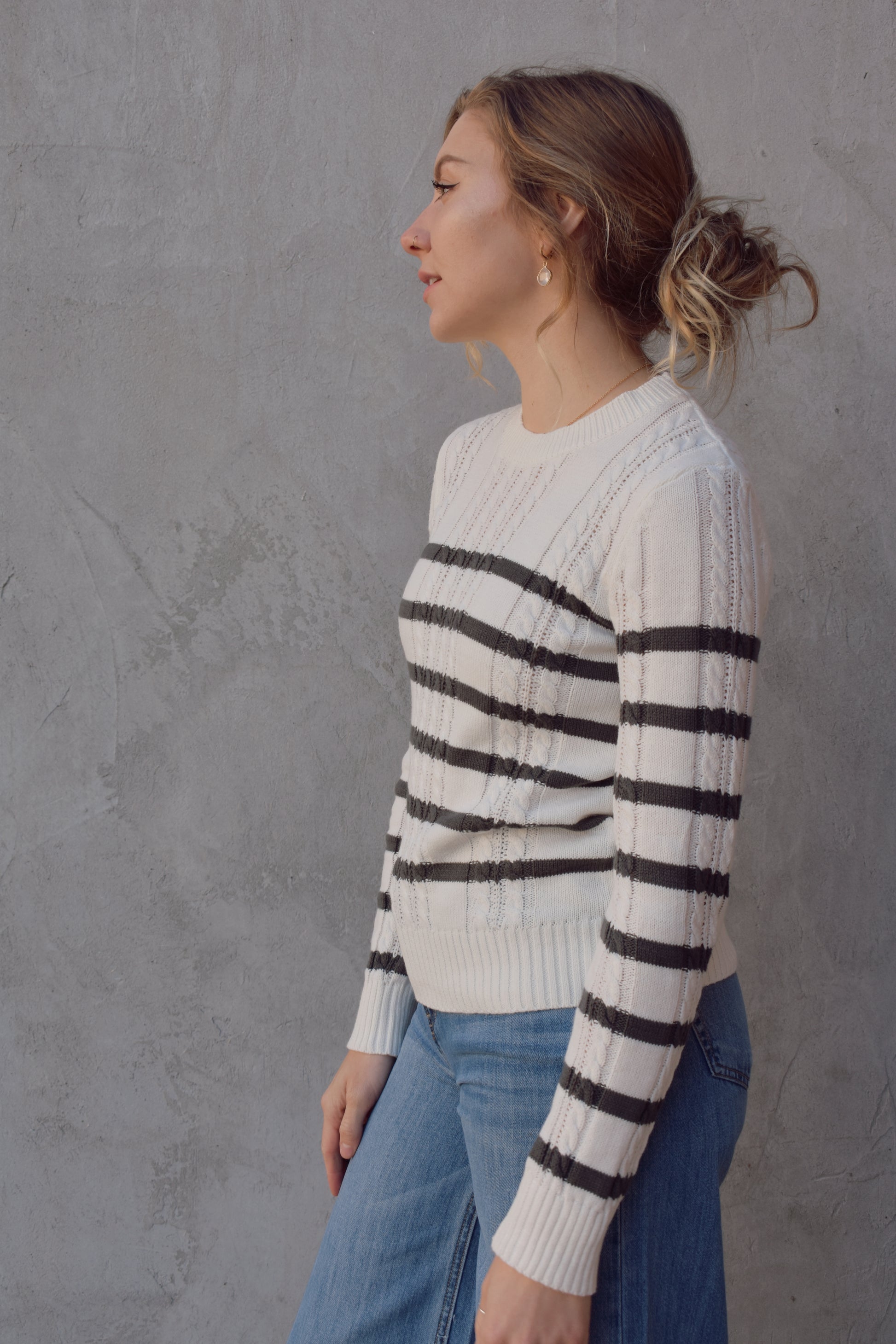 ivory crew neck long sleeve lightweight cable sweater with grey horizontal stripes across bodice and sleeves. cable texture is vertical. full length, ribbed cuffs, hem and neckline. 