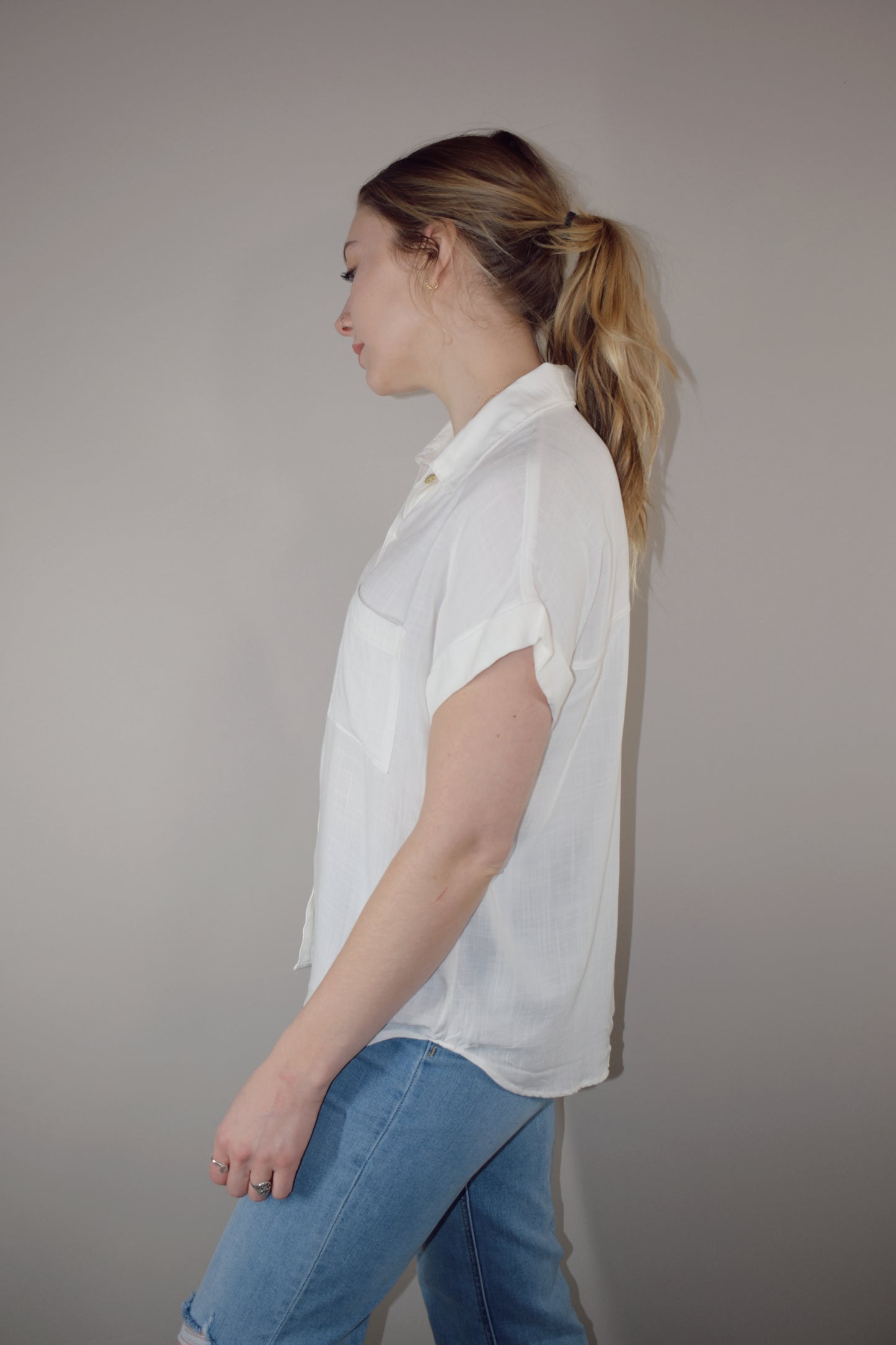 rayon white short sleeve collared button down with cuffed sleeves, one breast patch pocket, loose fit, full length, lightweight.