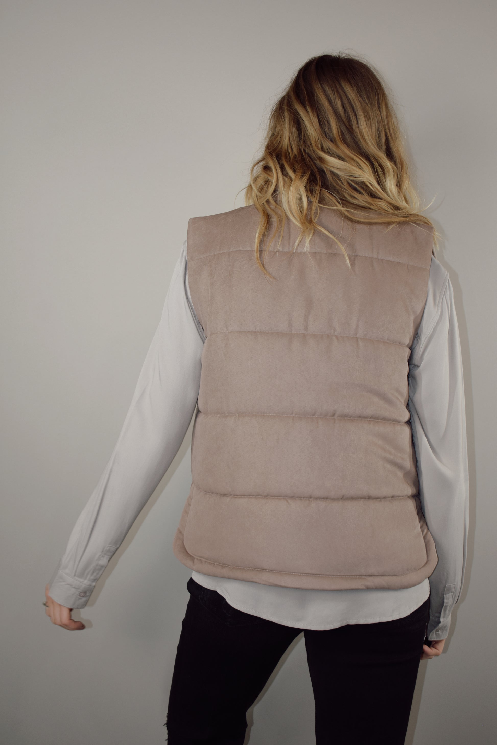 super soft suede like fabric full length puffer vest with collar zip and snap front enclosure has pockets 