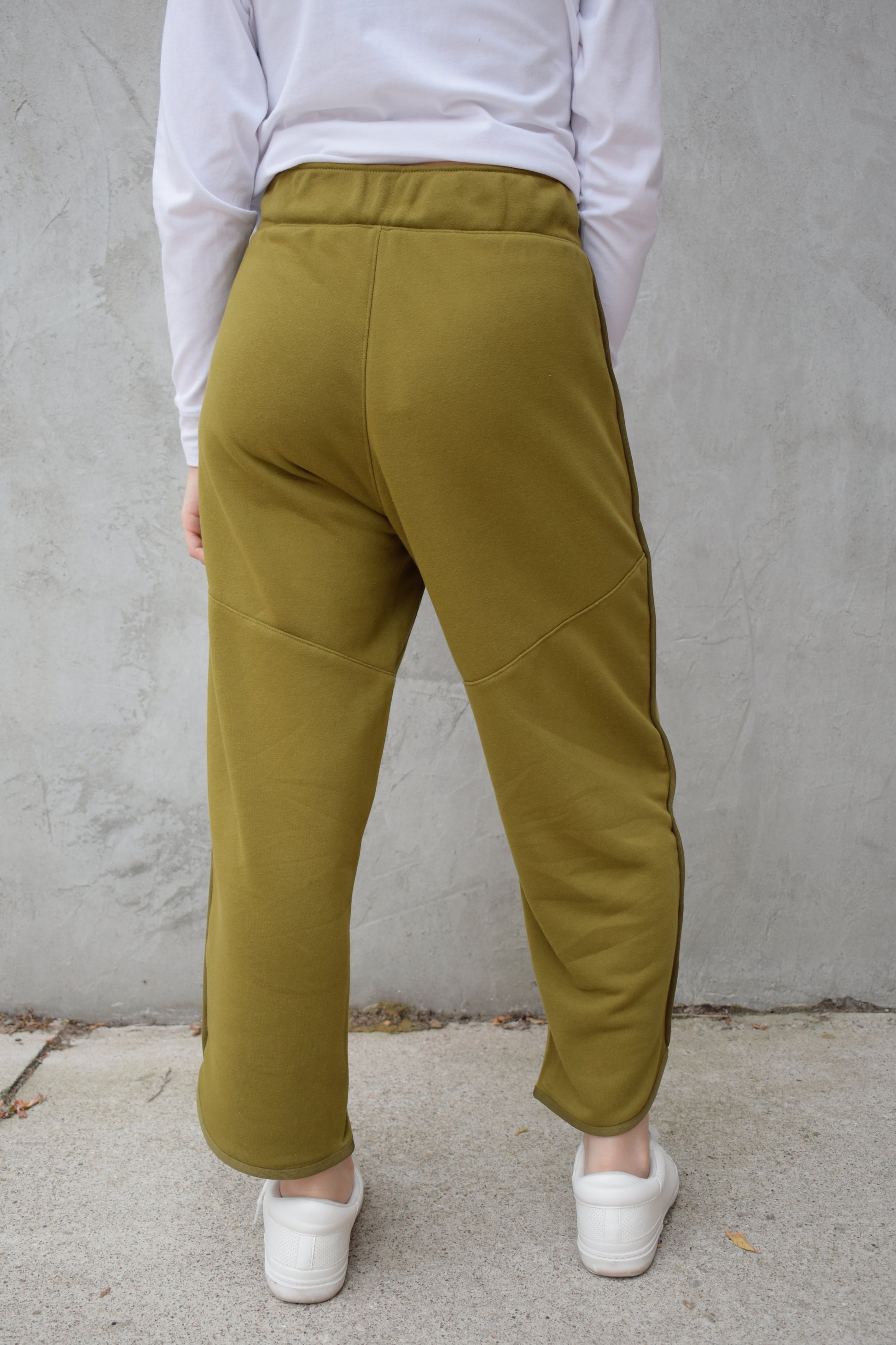 lounge pants with relaxed cropped fit, curved hem, oversized front bucket patch pockets, elastic waistband, seam detailing along sides, athleisure