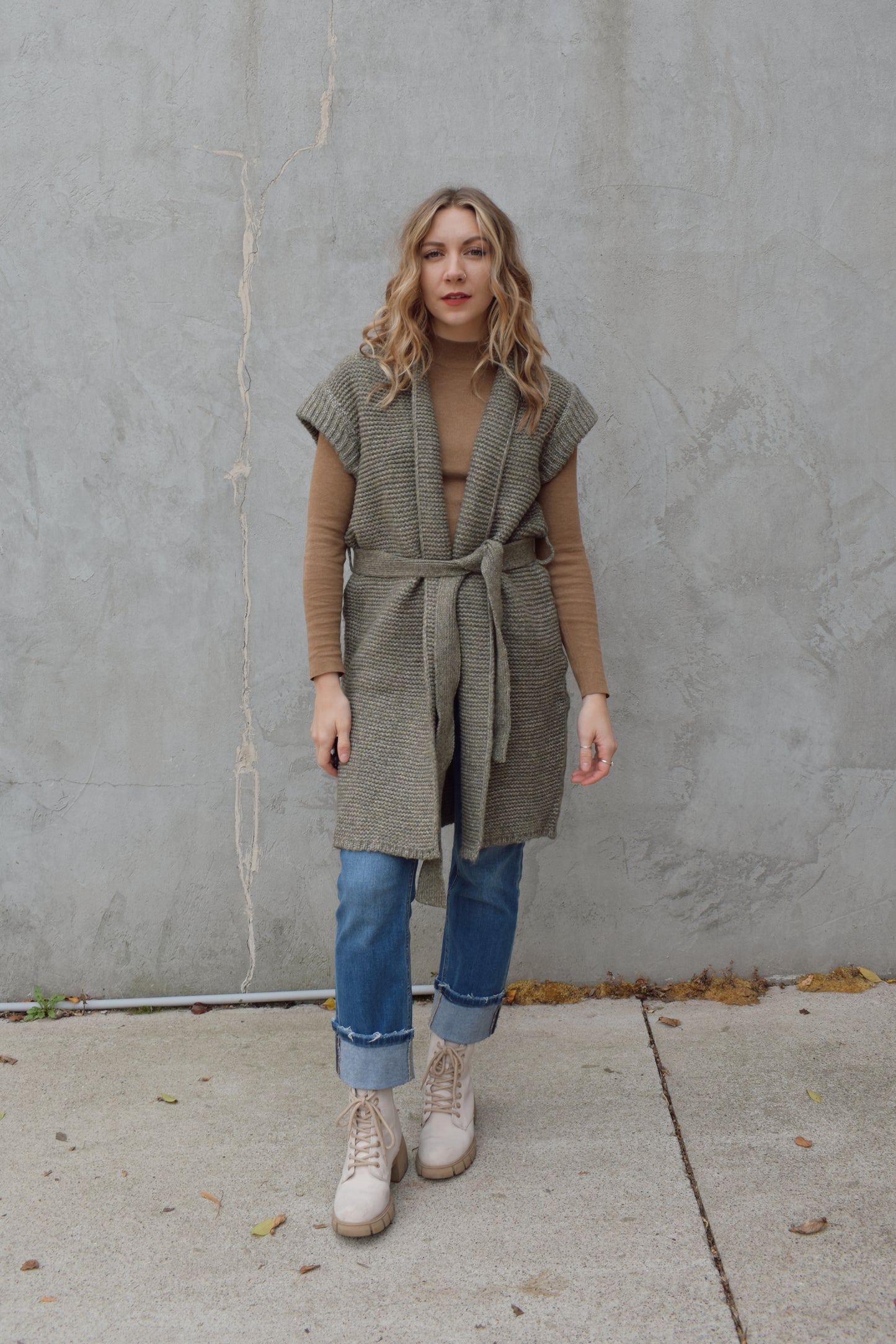 belted sleeveless cardigan vest with thick cap sleeve detail. woven olive gray material. hits above the knee.