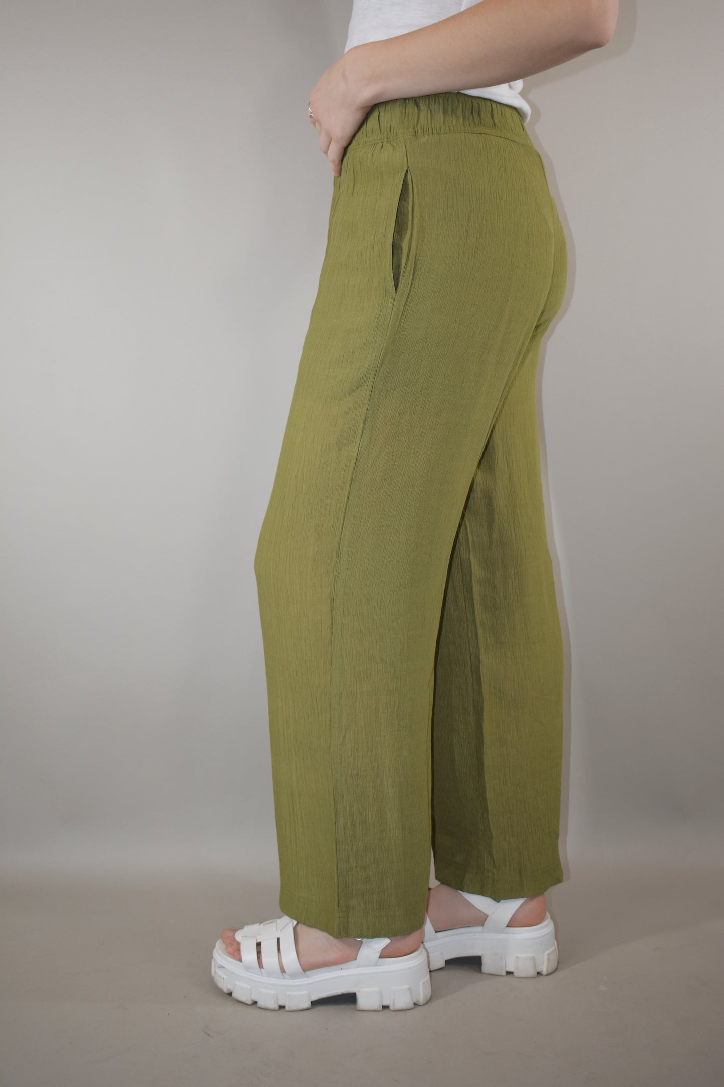 breezy lightweight olive pants slight wide leg high waisted with elastic waistband and shorts length liner has pockets in front not in back