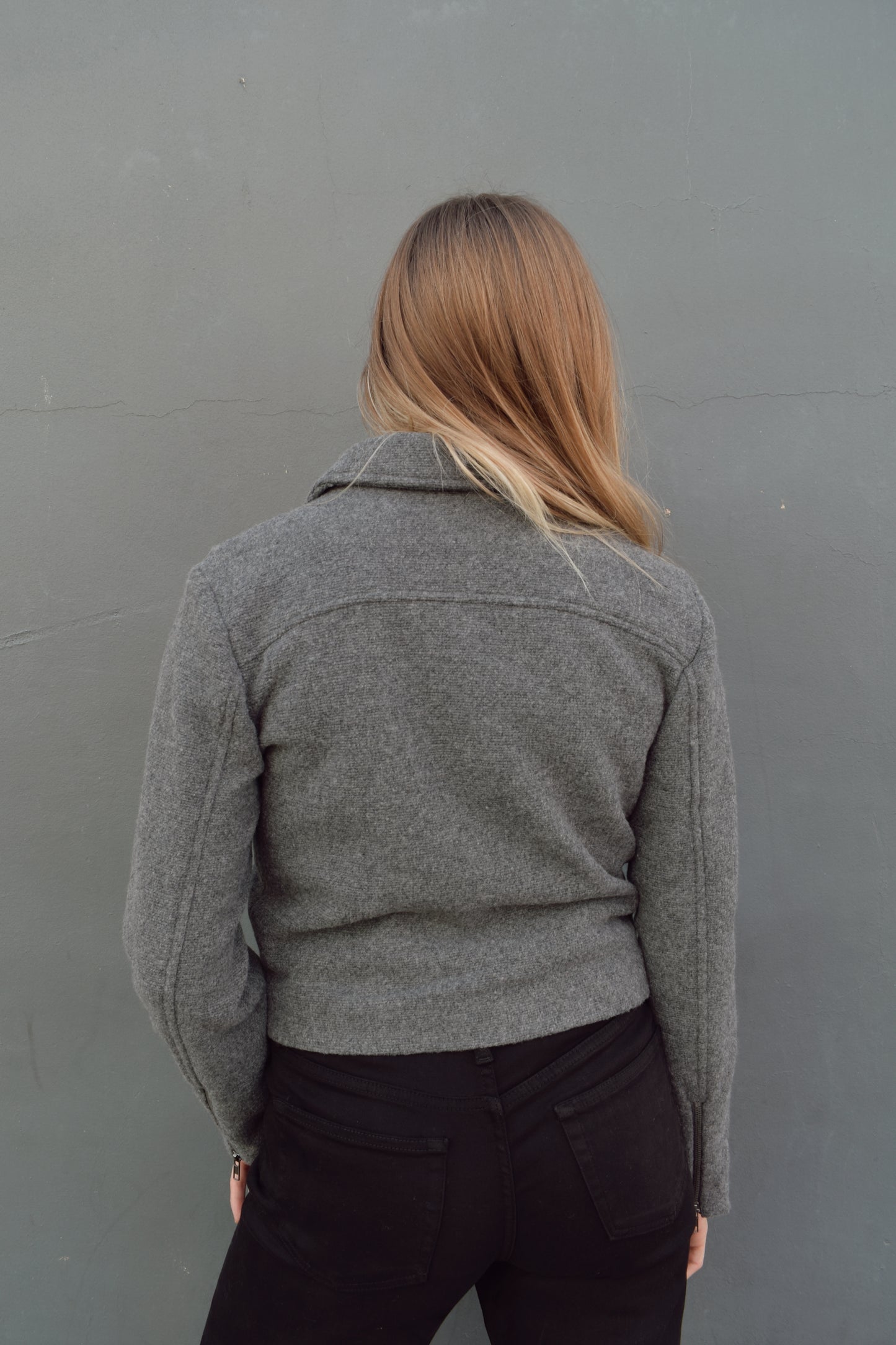 slightly cropped grey moto jacket with notched collar and zip enclosure and has pockets