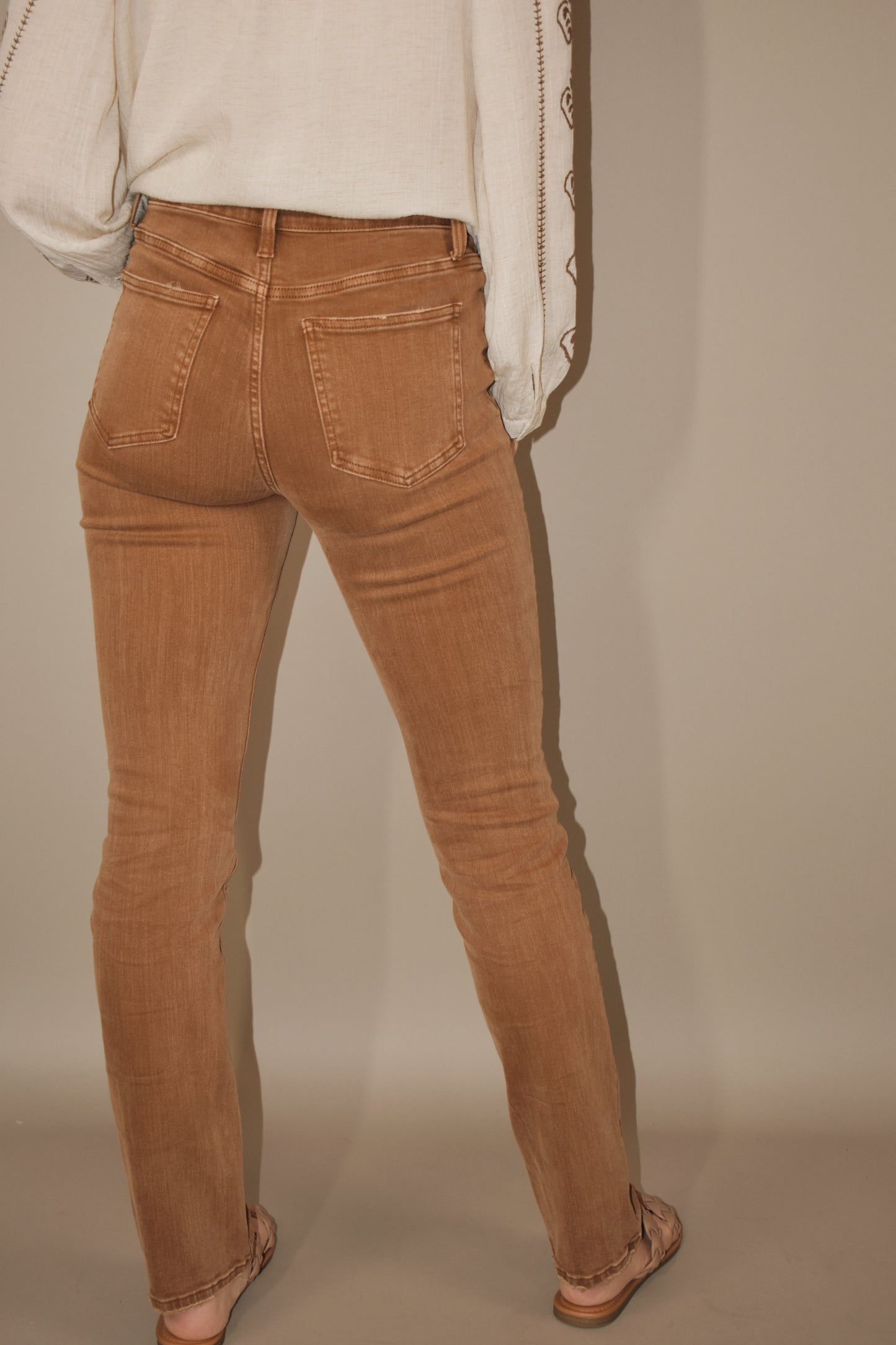 Toffee colored denim. Stretch denim. High waisted. Slim straight leg, full length. No holes or distressing. Zip and button enclosure. 