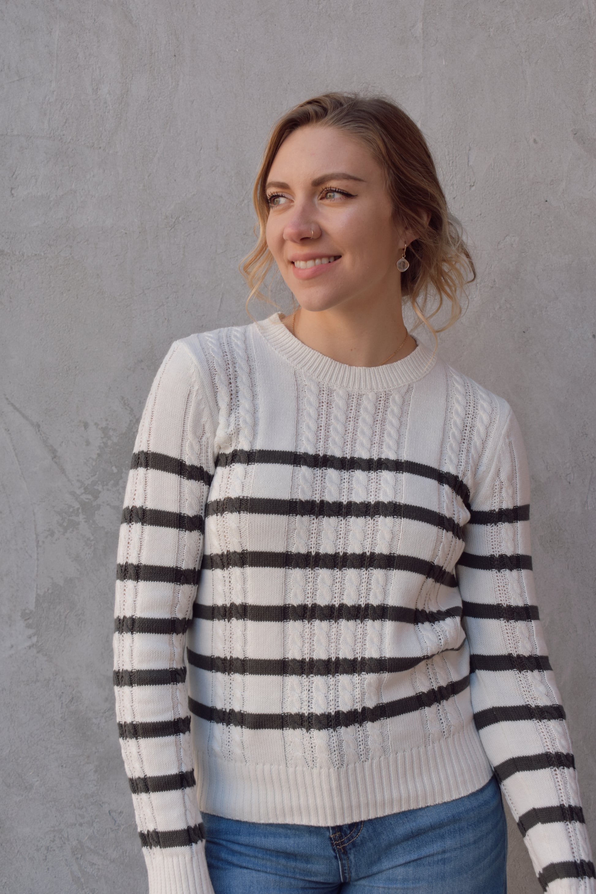 ivory crew neck long sleeve lightweight cable sweater with grey horizontal stripes across bodice and sleeves. cable texture is vertical. full length, ribbed cuffs, hem and neckline. 