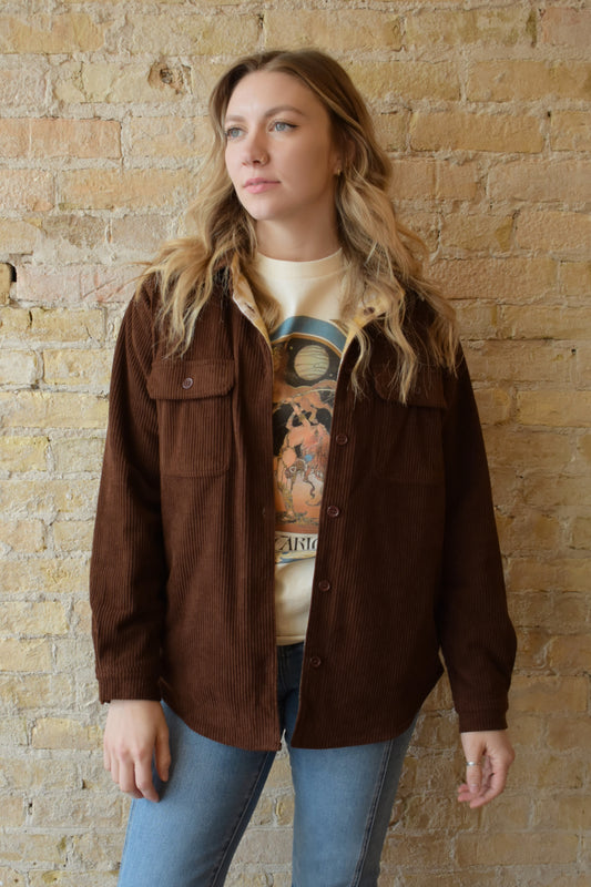 dark brown corduroy shacket lined with mustard color plaid flannel, reversible, one side has breast pockets the other has side front pockets, button down, relaxed fit full length
