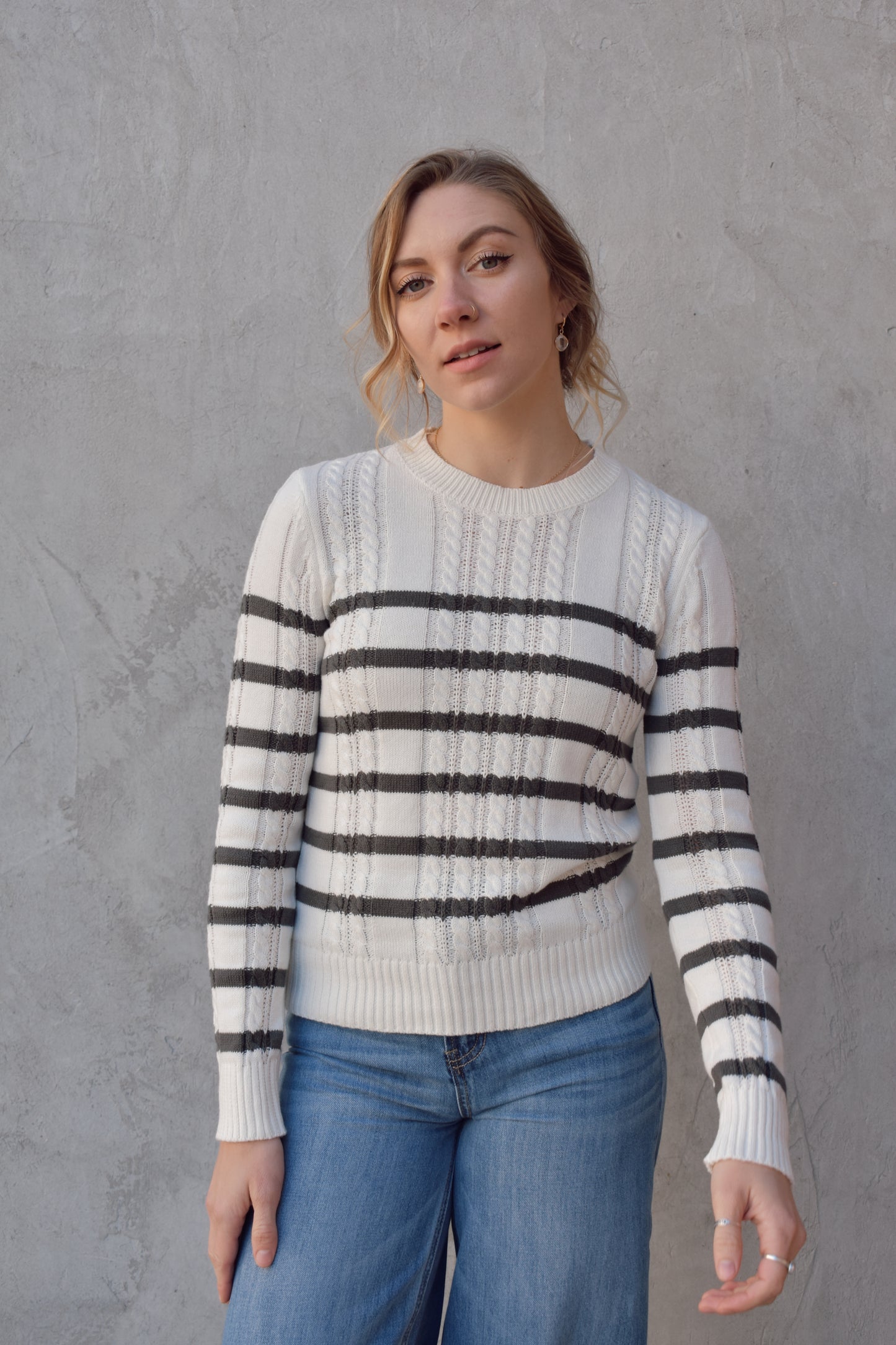 ivory crew neck long sleeve lightweight cable sweater with grey horizontal stripes across bodice and sleeves. cable texture is vertical. full length, ribbed cuffs, hem and neckline. 