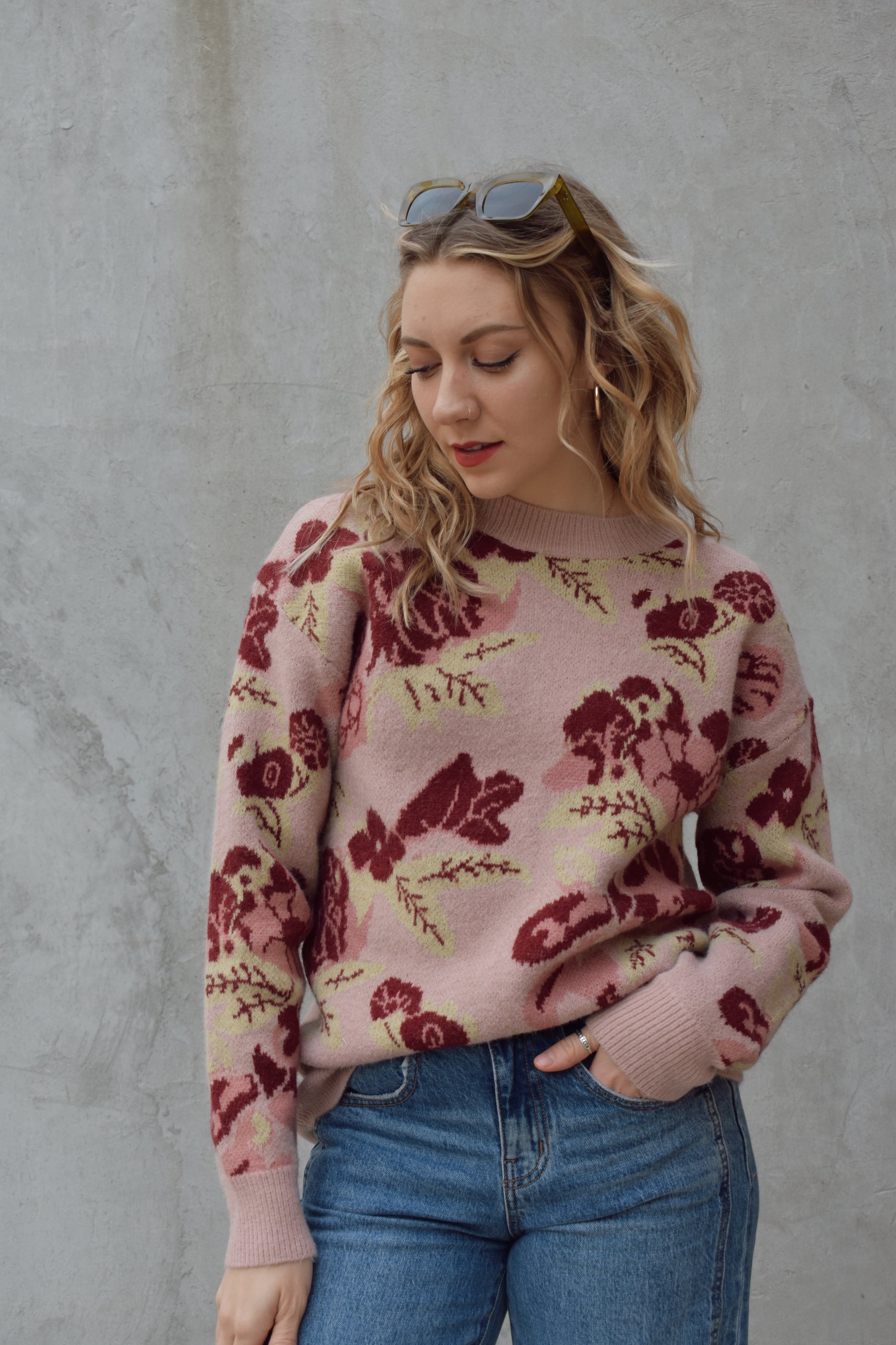 crew neck sweater full length relaxed fit drop shoulder with dusty rose background and floral and leaf design in shades of red pink and light green 