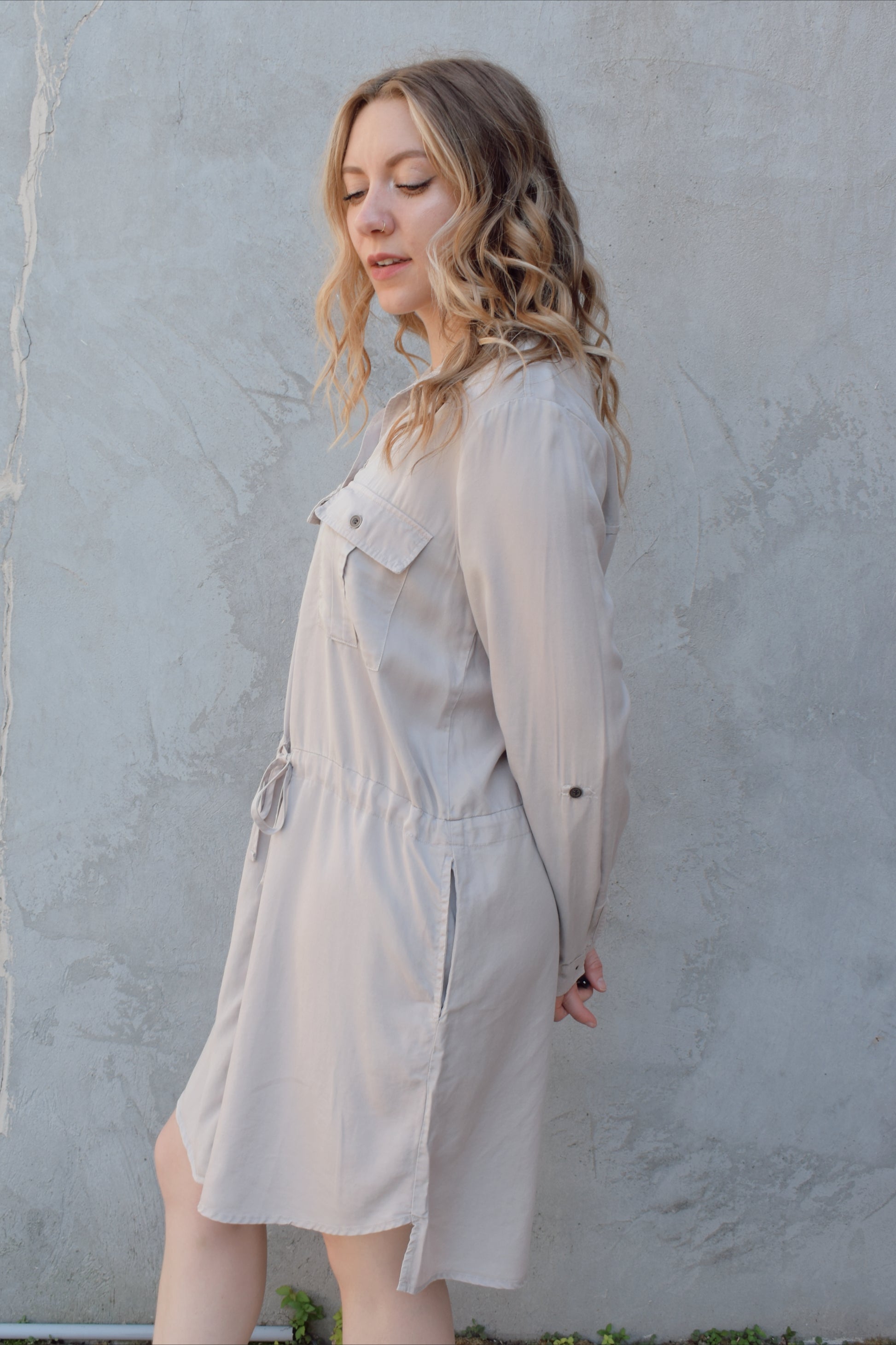 tencel utility long sleeve mini dress with cuff and button sleeves, button down front enclosure, drawstring at waist, breast utility patch pockets with flap and button enclosure, has side pockets, scoop and side slit hem, loose fit