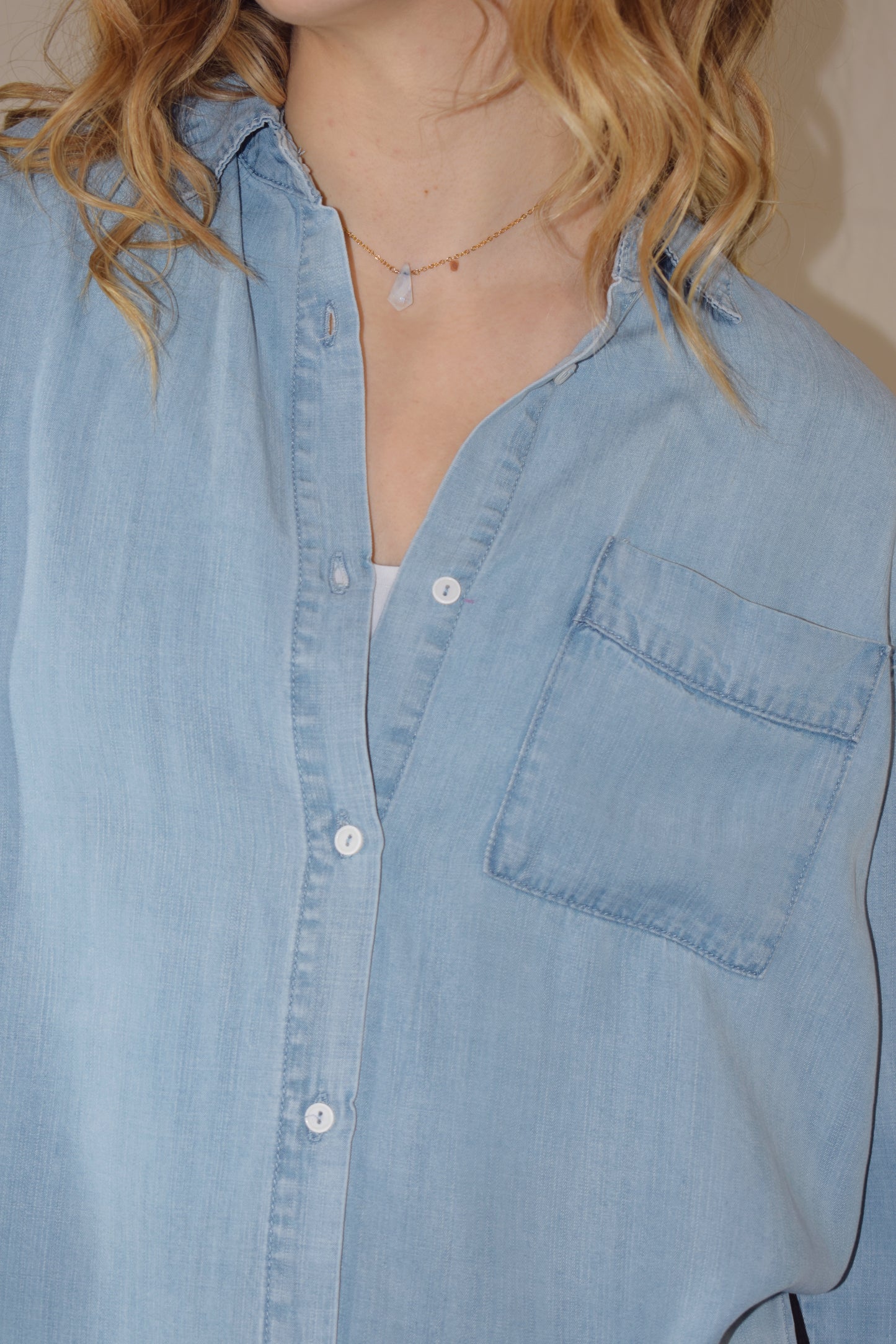 Tencel light wash denim long sleeve button down with one breast patch pocket full length