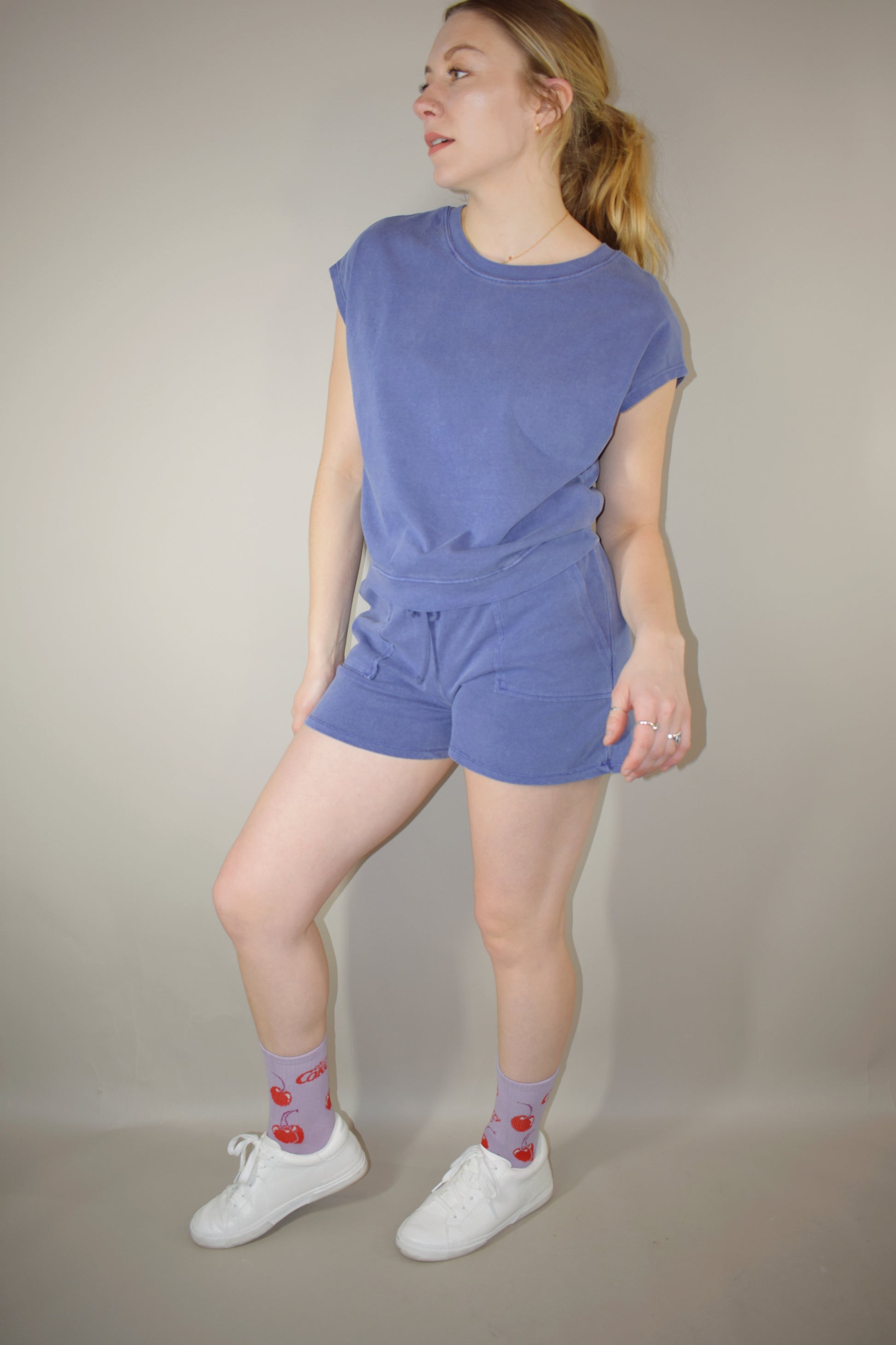 athleisure set with cap sleeve/ tank style top relaxed fit with crew neckline and athletic shorts that hit upper thigh with front pockets and a elastic waistband with drawstring