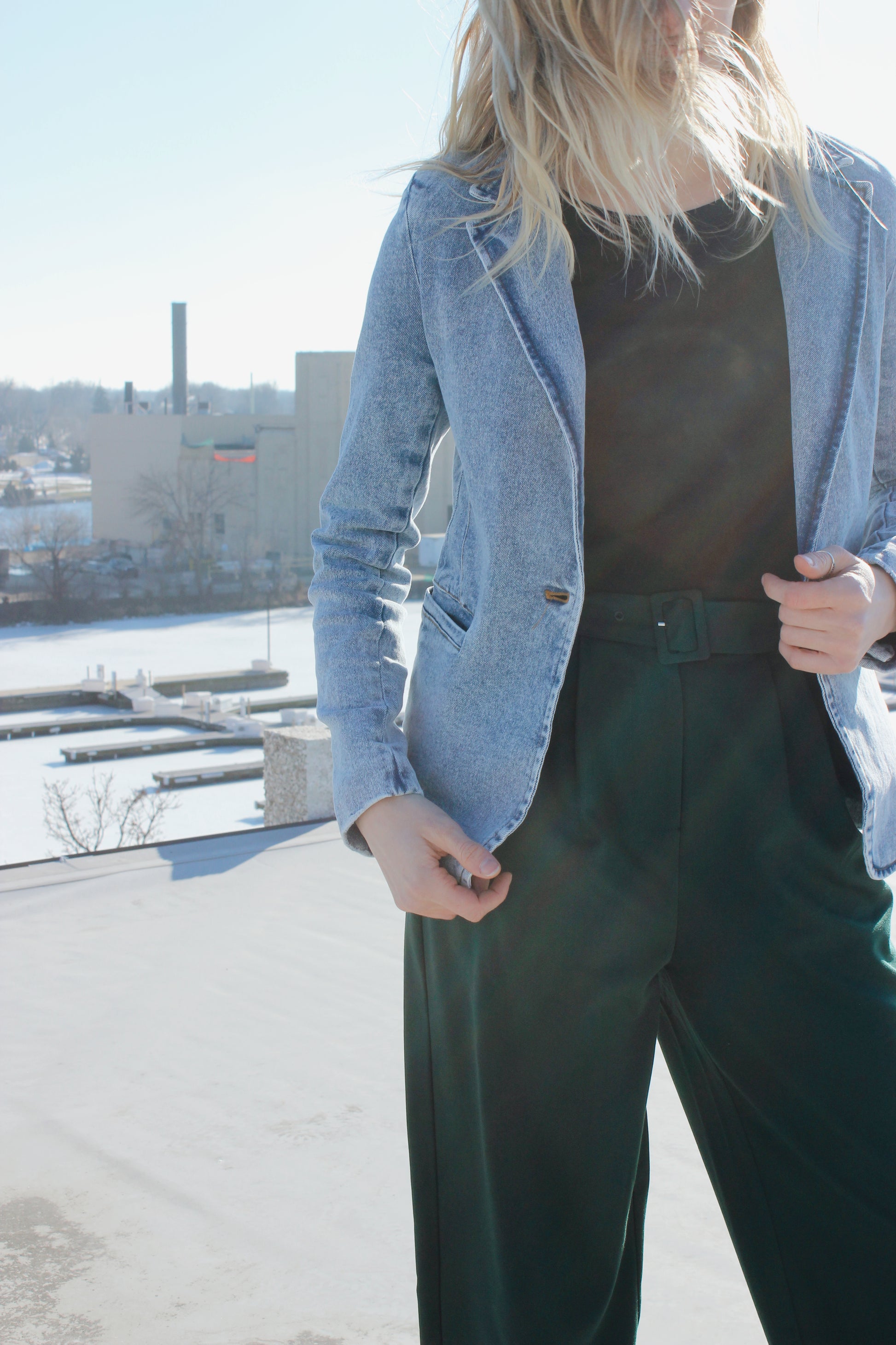 fitted light to medium wash blazer with one denim button enclosure and front pockets that open on the top. slit in back 