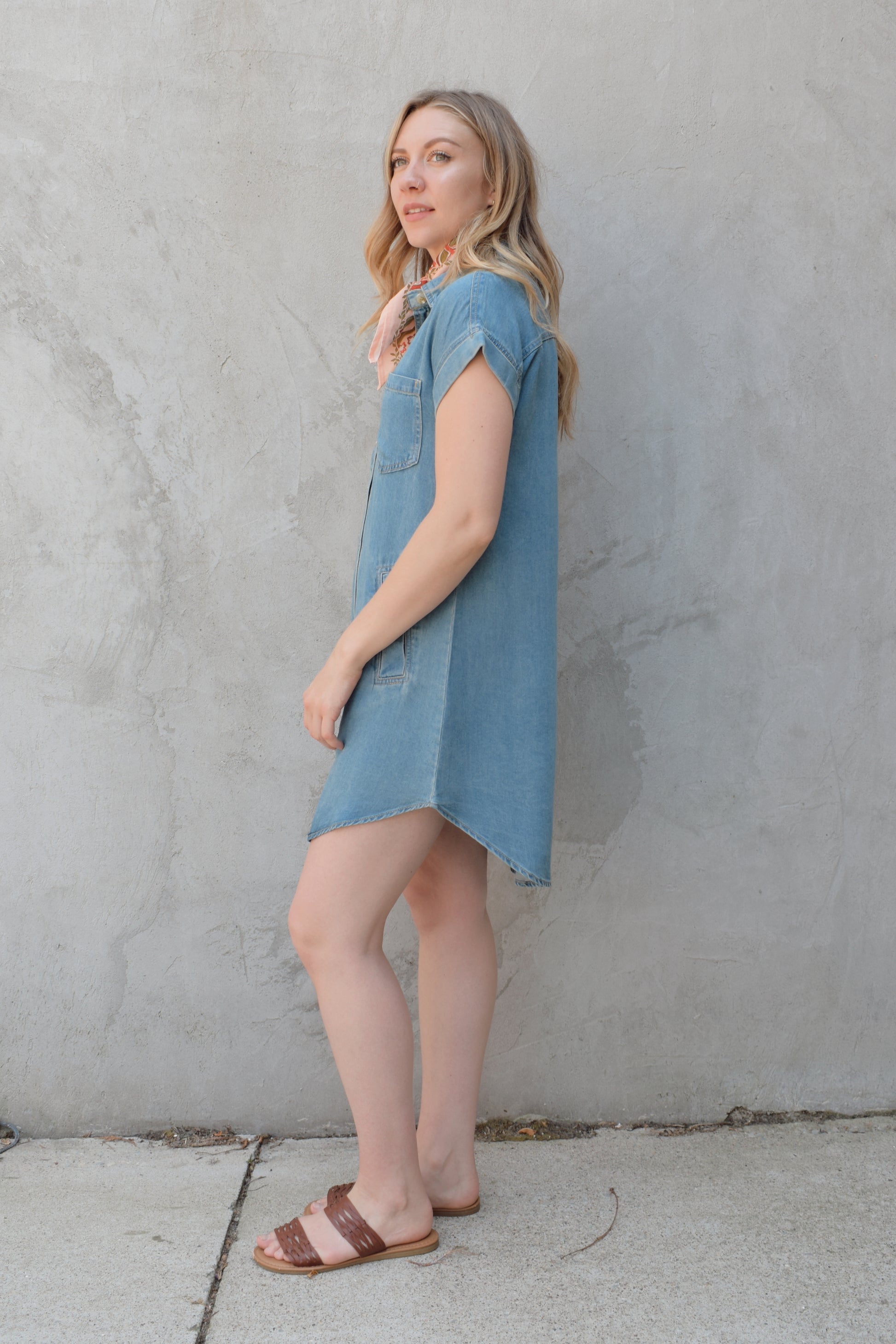 short sleeve button down denim colored medium wash mini dress straight fit has front pockets and patch breast pockets has collar and buttons down the whole front