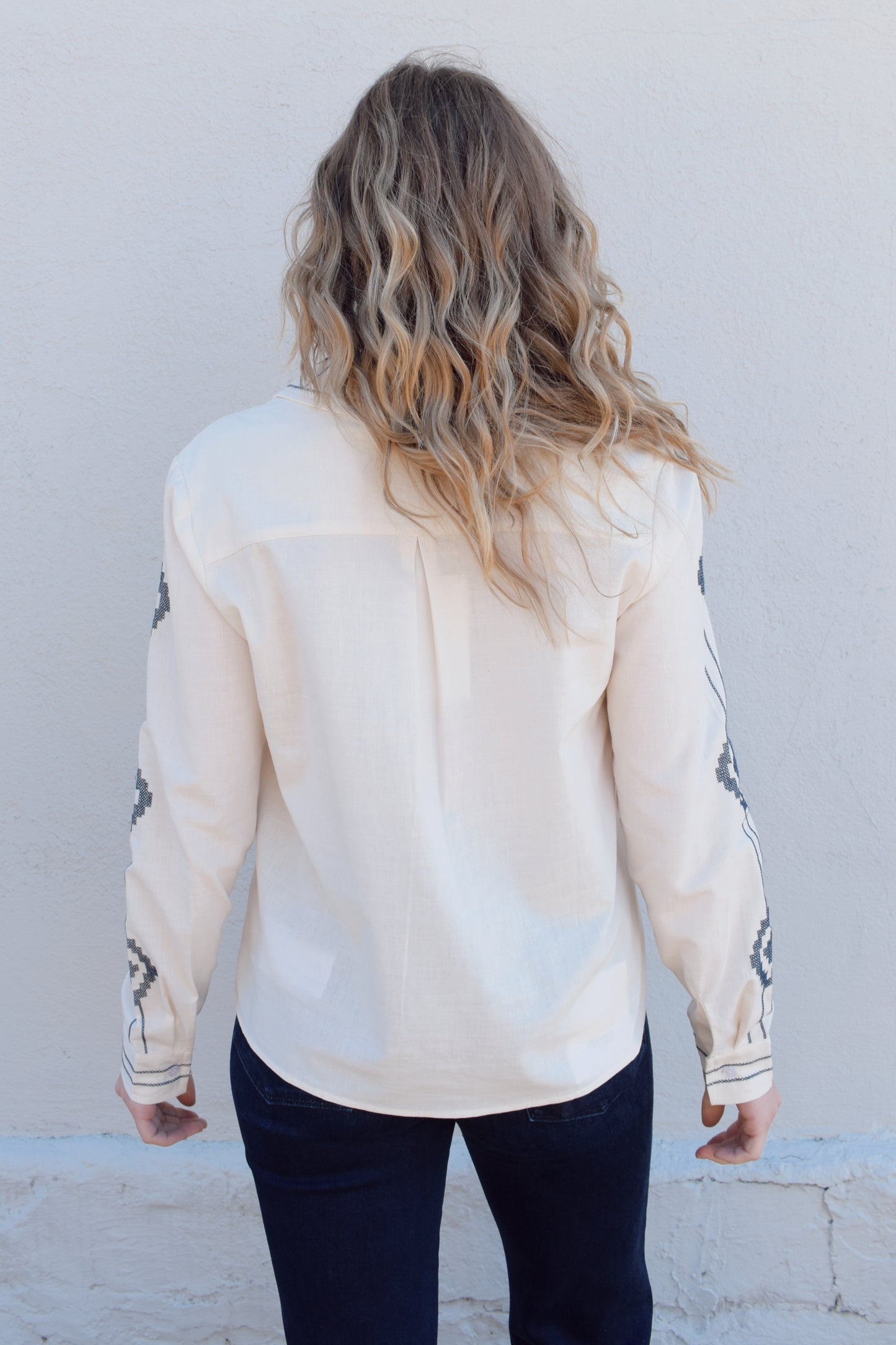 ivory button down full length with denim blue embroidery details along front, down sleeves, collar and cuffs. button cuffs, straight relaxed fit