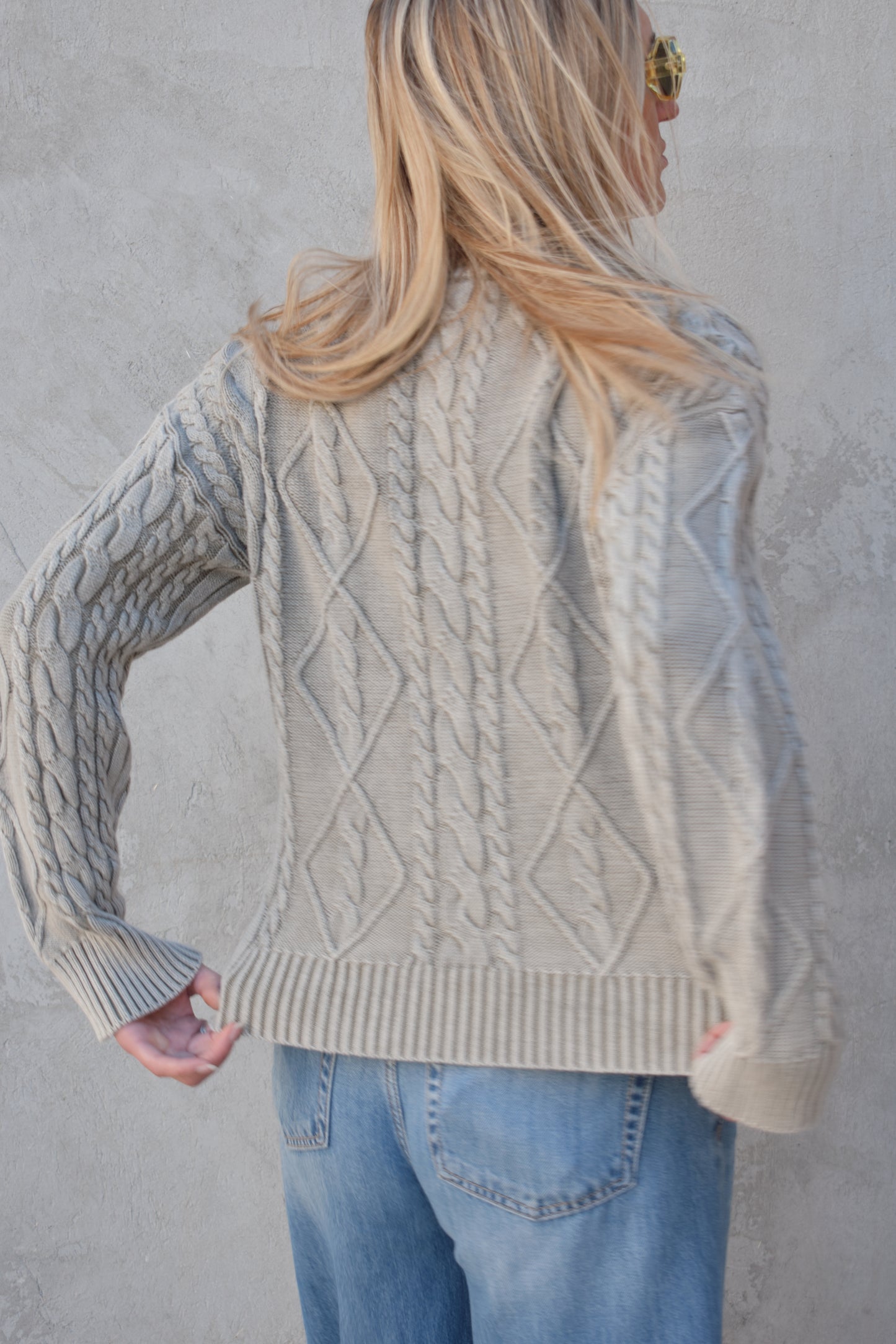 light gray twisted cable high neck sweater with front zip enclosure and it zips from both ways. ribbed cuffs, neck, and hem. drop shoulders.