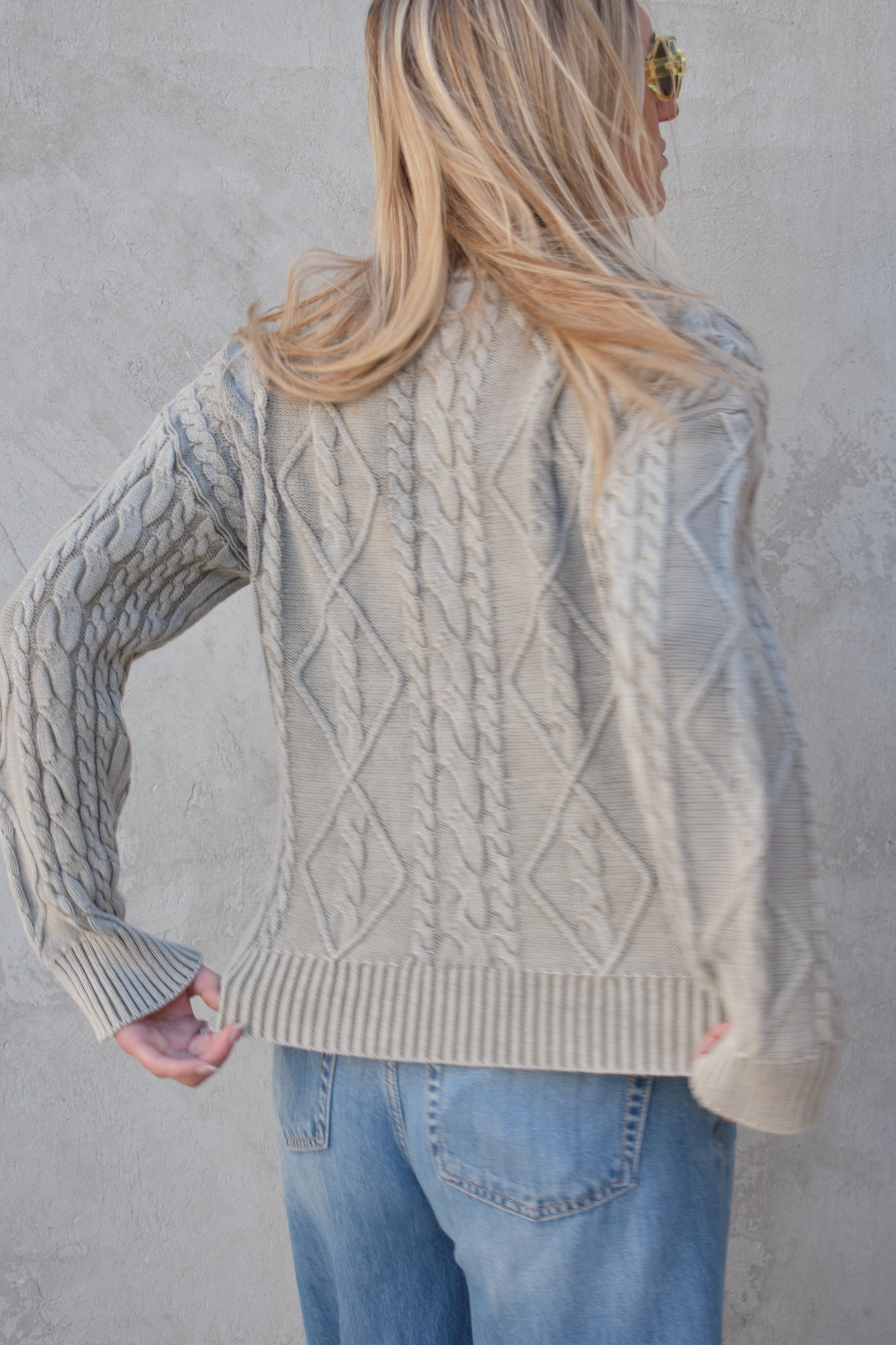 light gray twisted cable high neck sweater with front zip enclosure and it zips from both ways. ribbed cuffs, neck, and hem. drop shoulders.