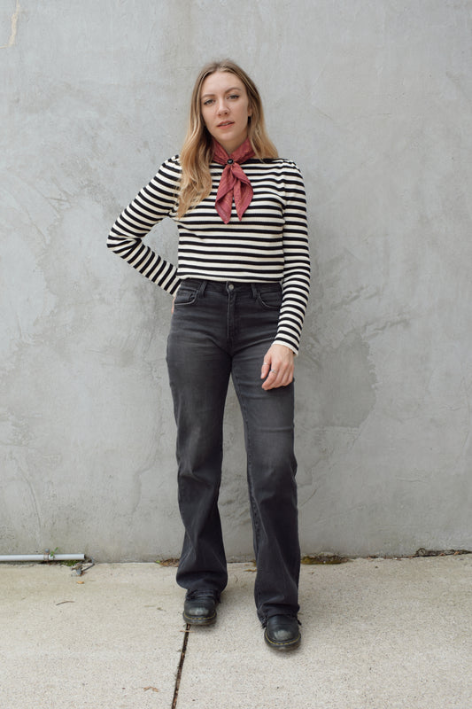 high rise washed black wide leg flare jeans full length stretch denim distressed hem but no holes zip and button enclosure has beltloops has front and back pockets 