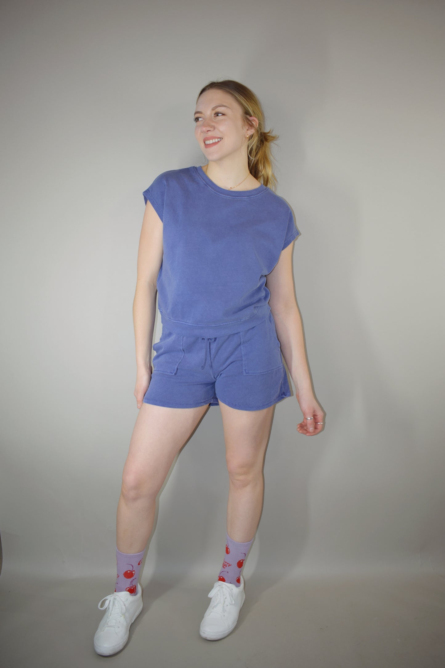 athleisure set with cap sleeve/ tank style top relaxed fit with crew neckline and athletic shorts that hit upper thigh with front pockets and a elastic waistband with drawstring