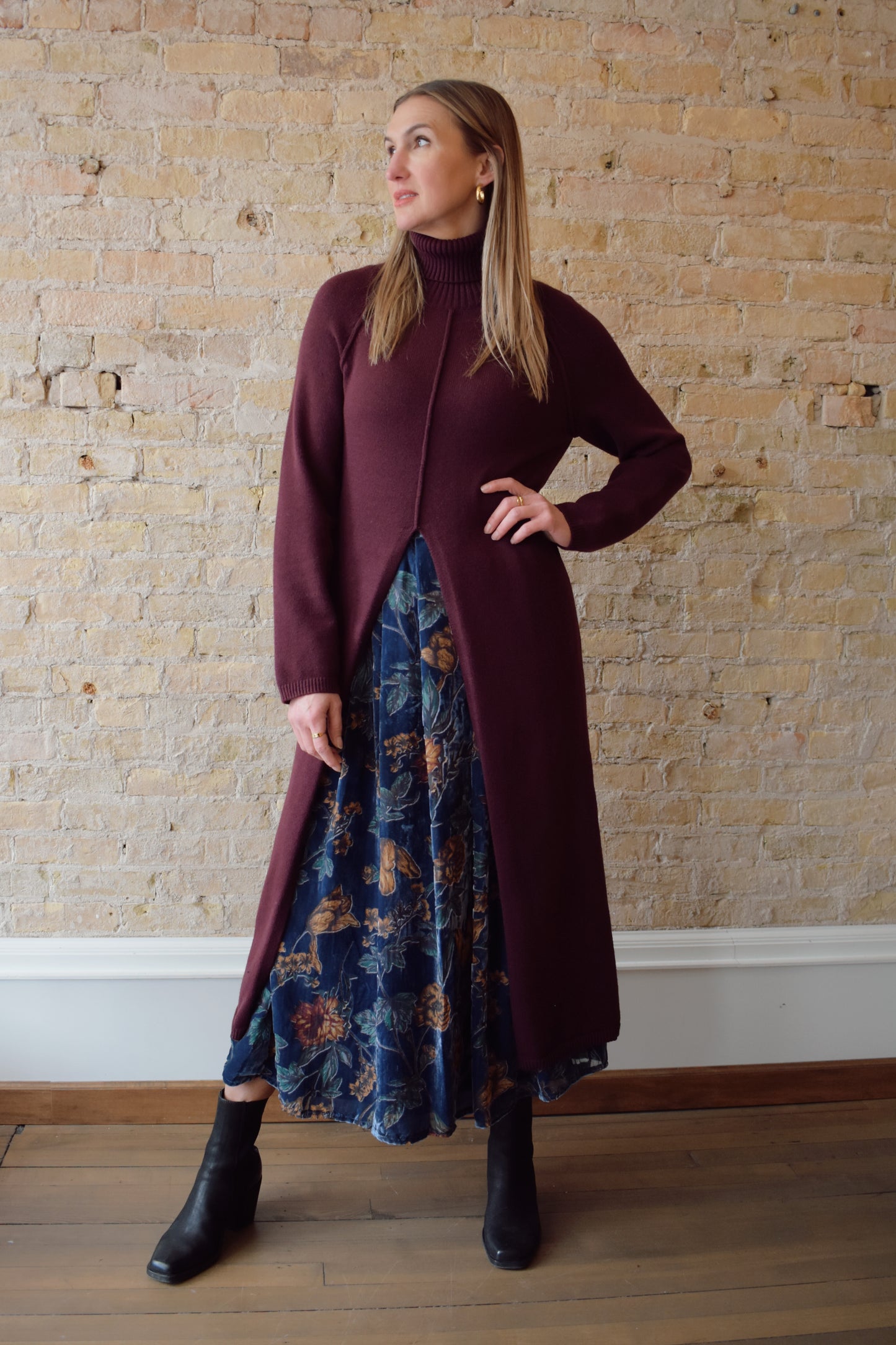 turtleneck tunic sweater dress with split in front up to above waistline, exposed seam detailing down the front and back